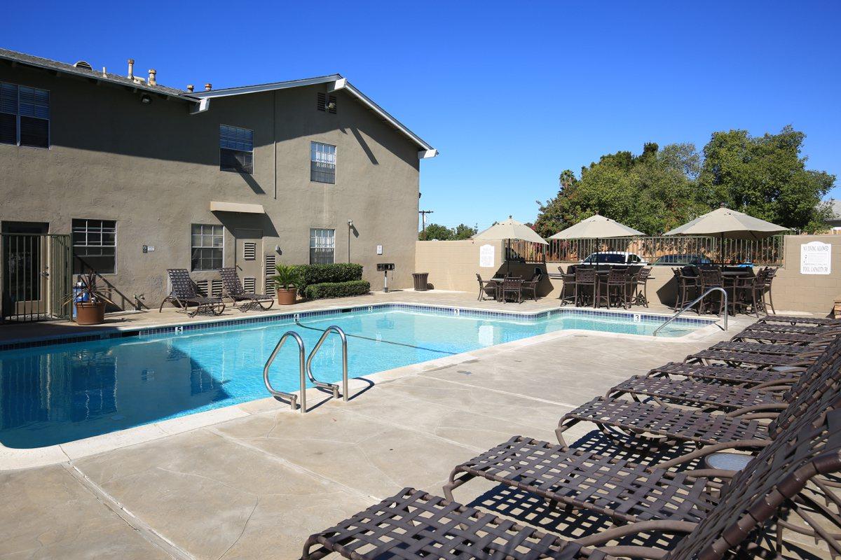 a house with a pool outside of a building