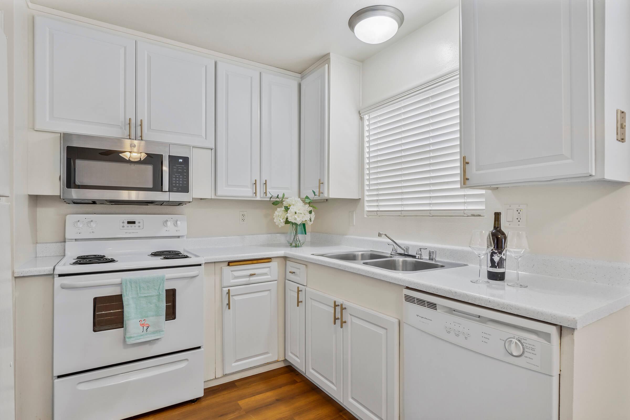 a kitchen with a stove sink and refrigerator