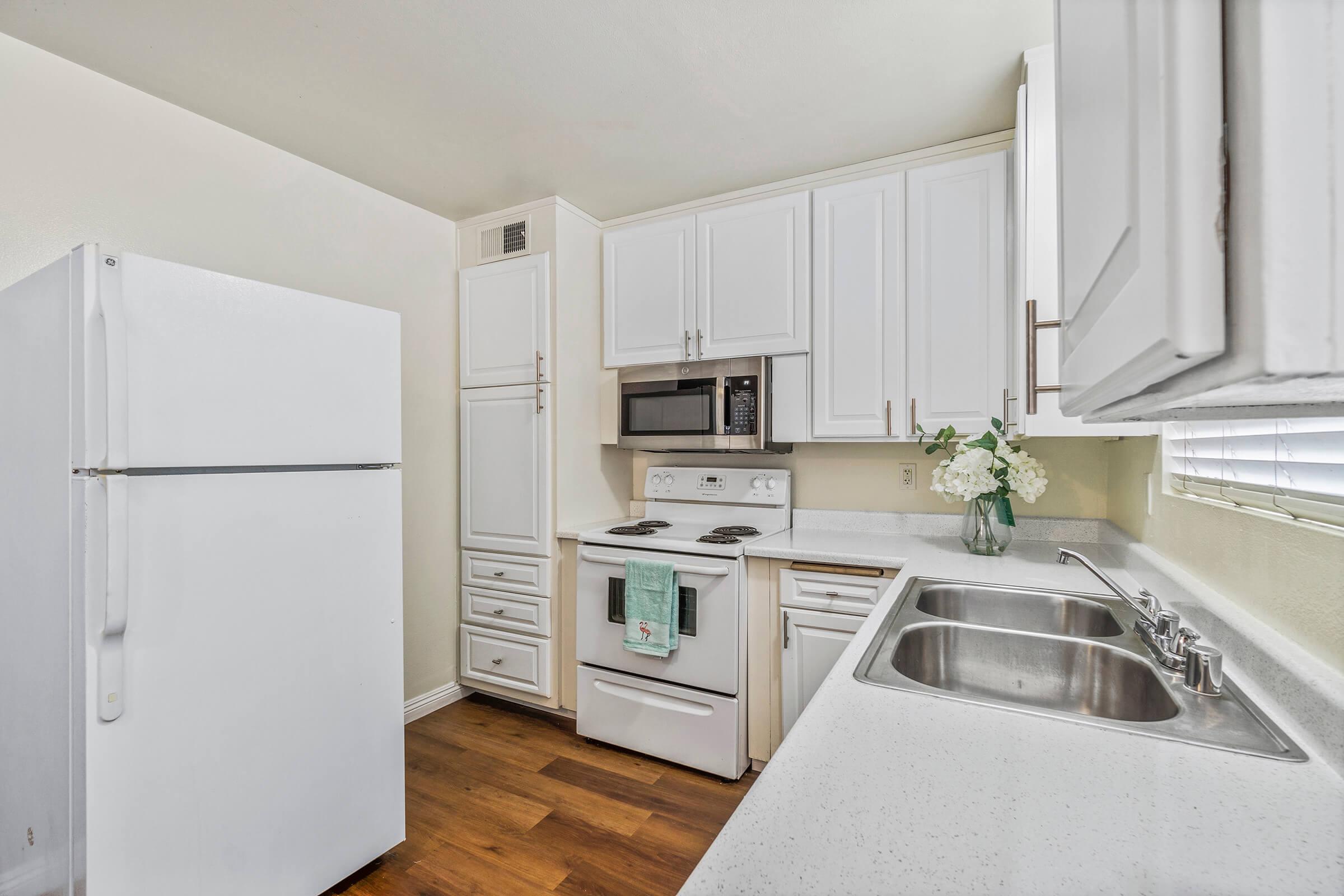 a kitchen with a stove sink and refrigerator