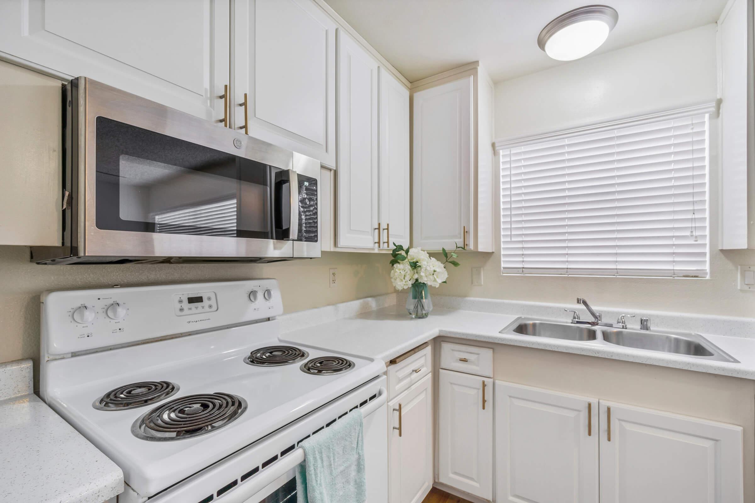 a stove top oven sitting inside of a kitchen