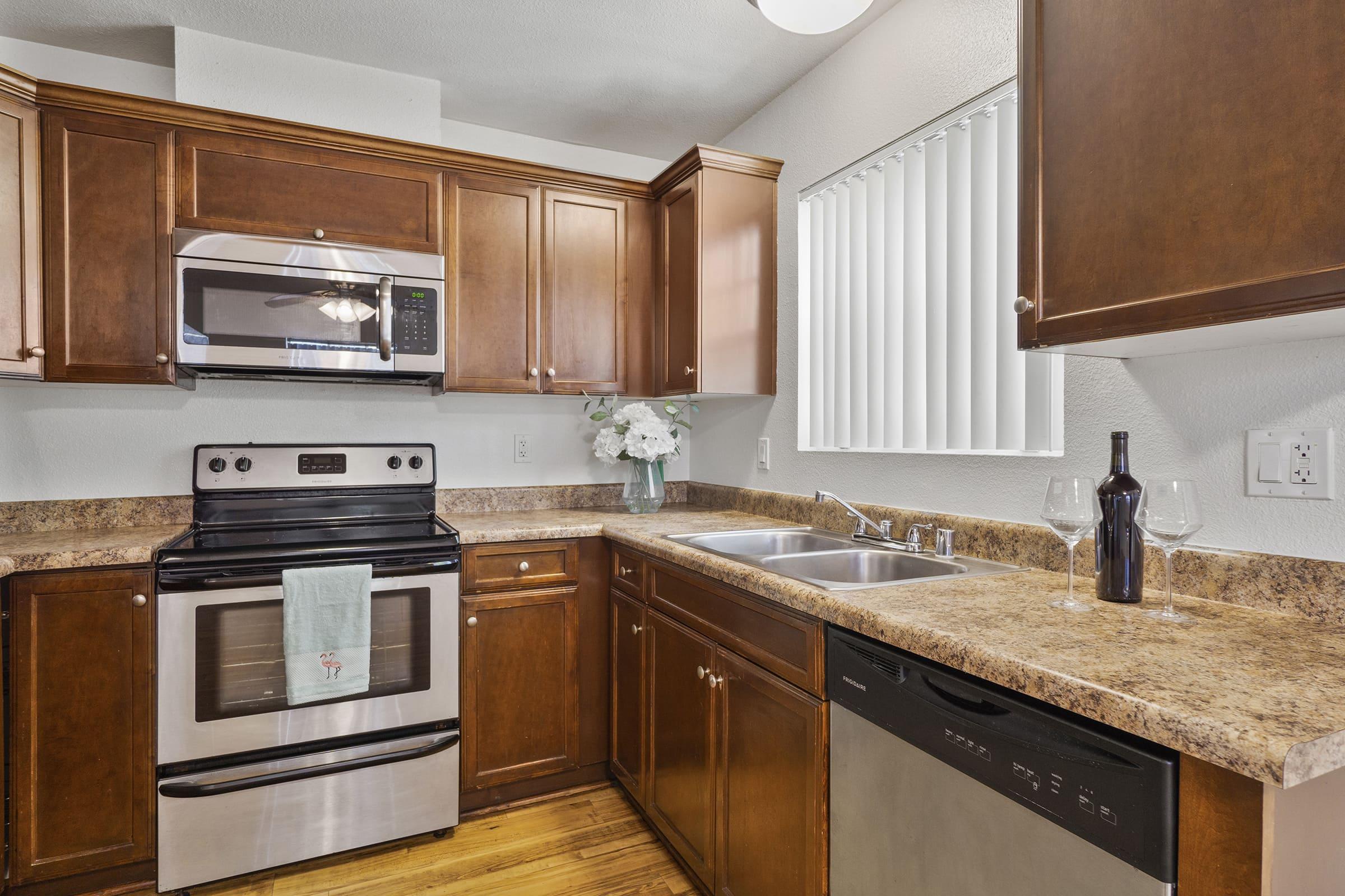 a modern kitchen with stainless steel appliances and wooden cabinets