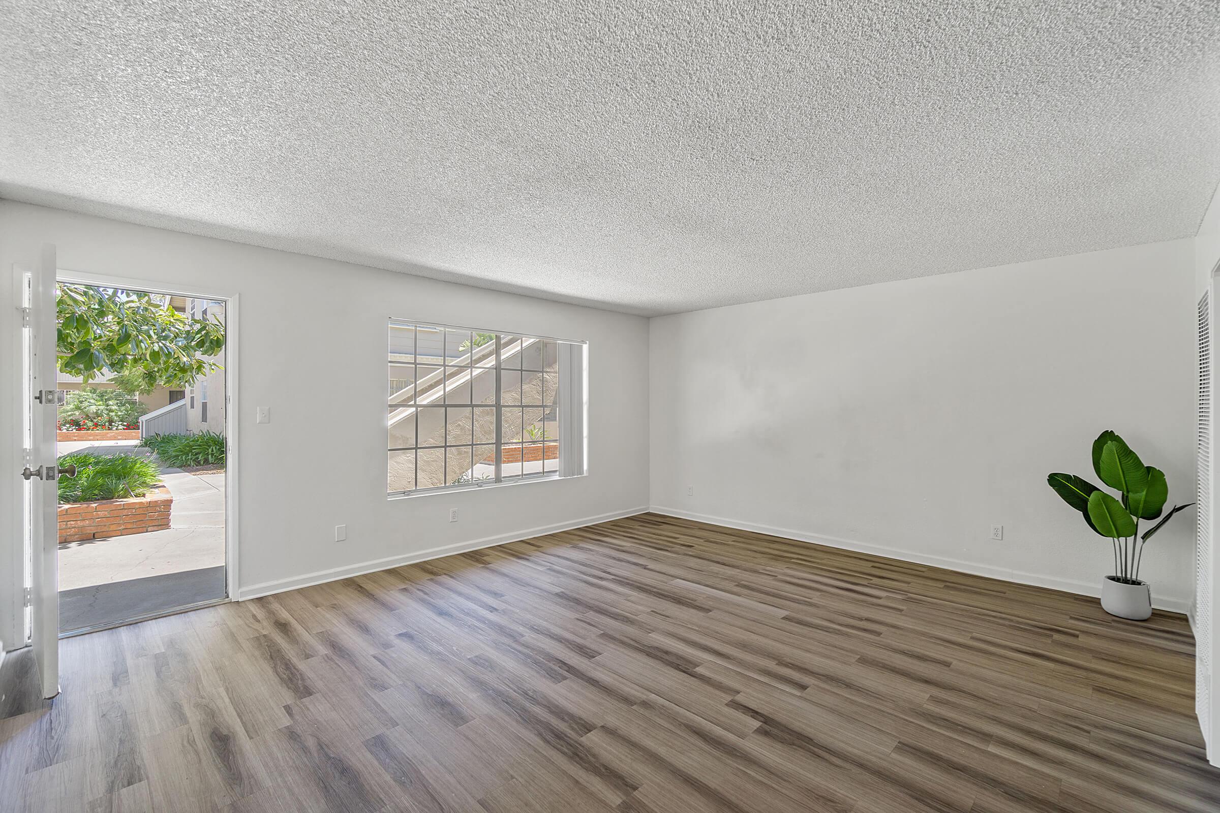 a room filled with furniture and vase of flowers