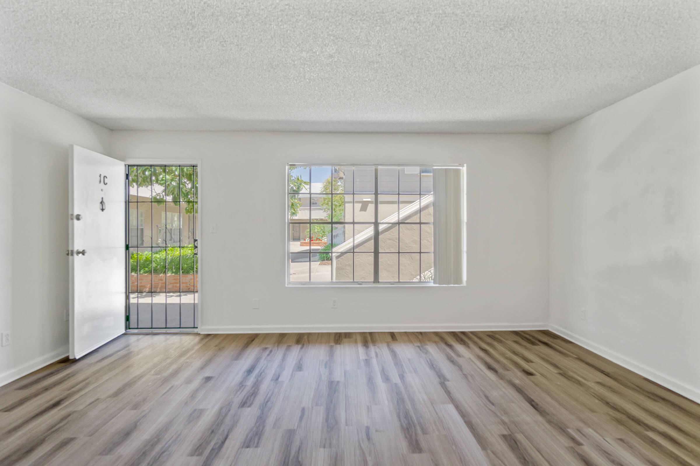 a close up of a hard wood floor next to a window