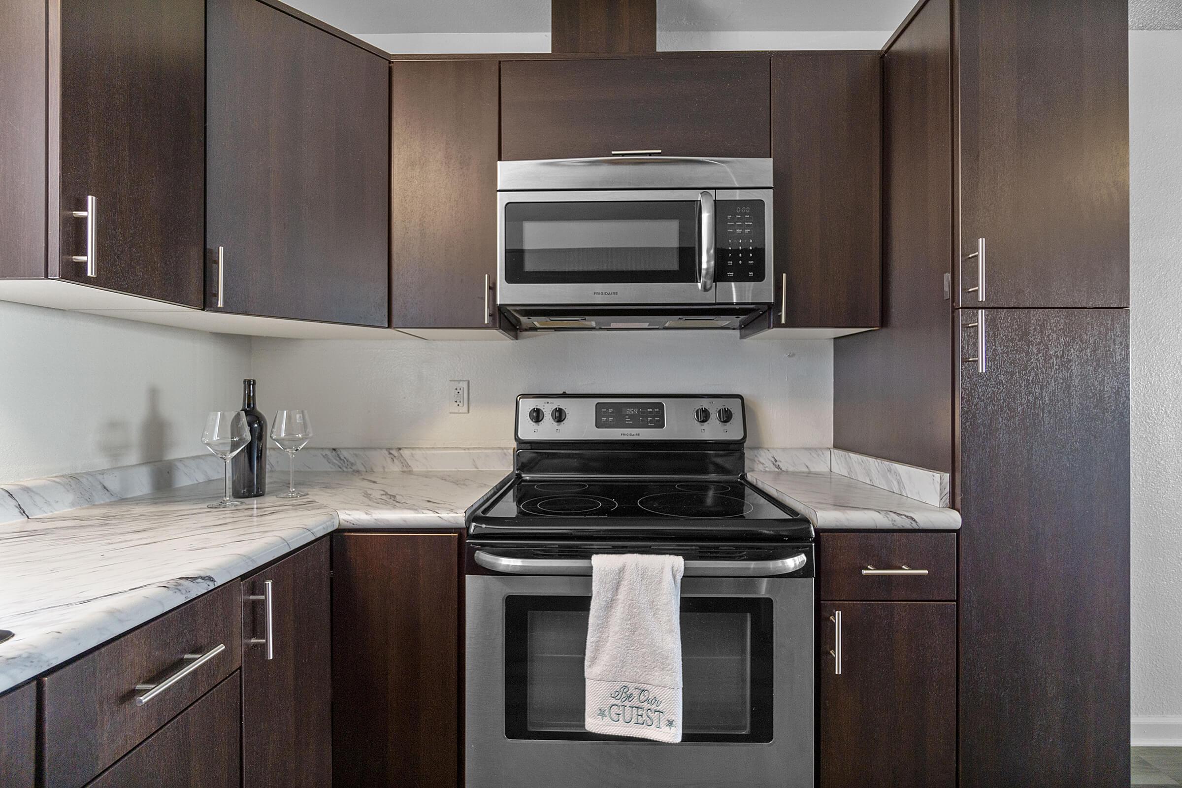 a stove top oven sitting inside of a kitchen