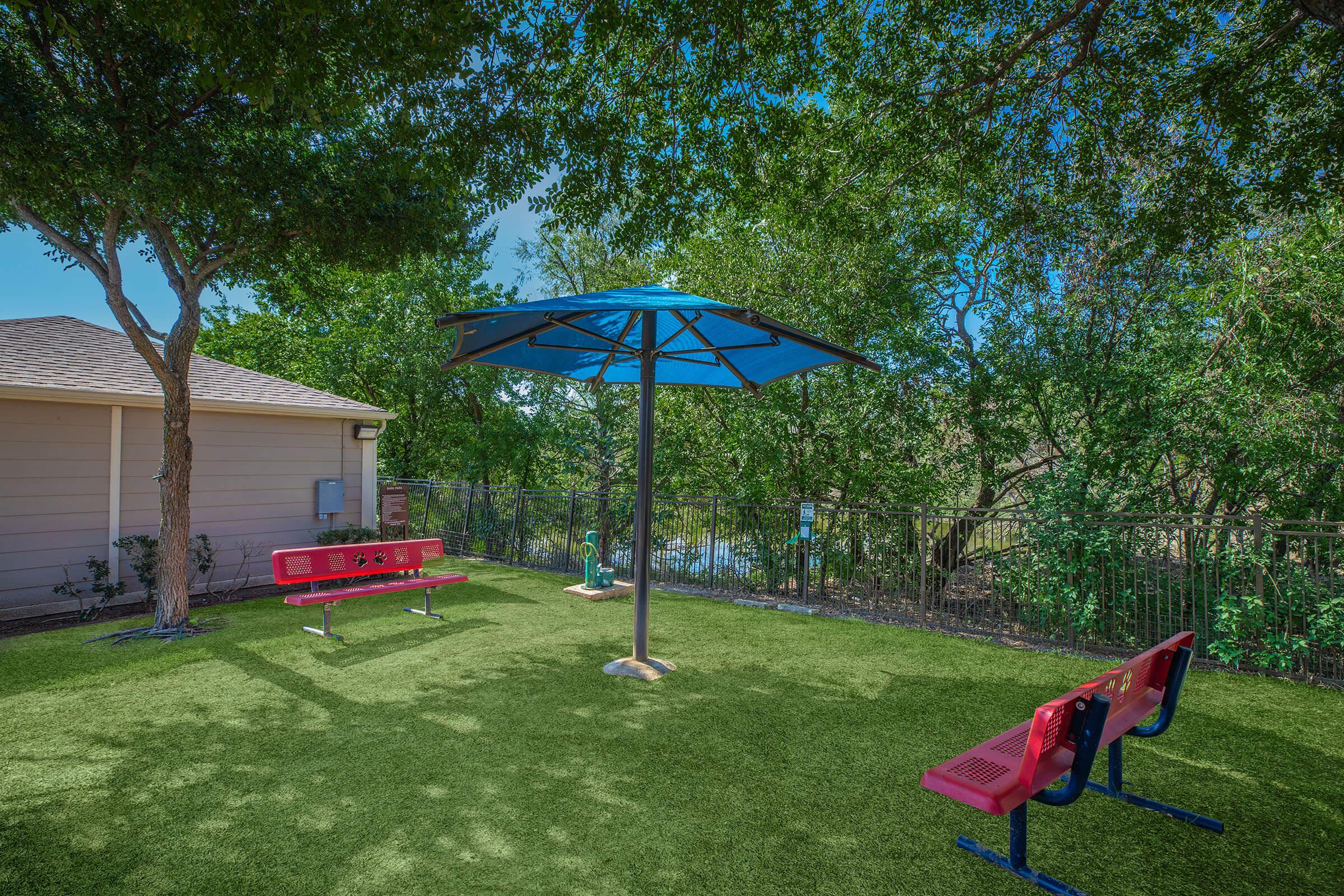 a group of lawn chairs sitting on top of a grass covered field