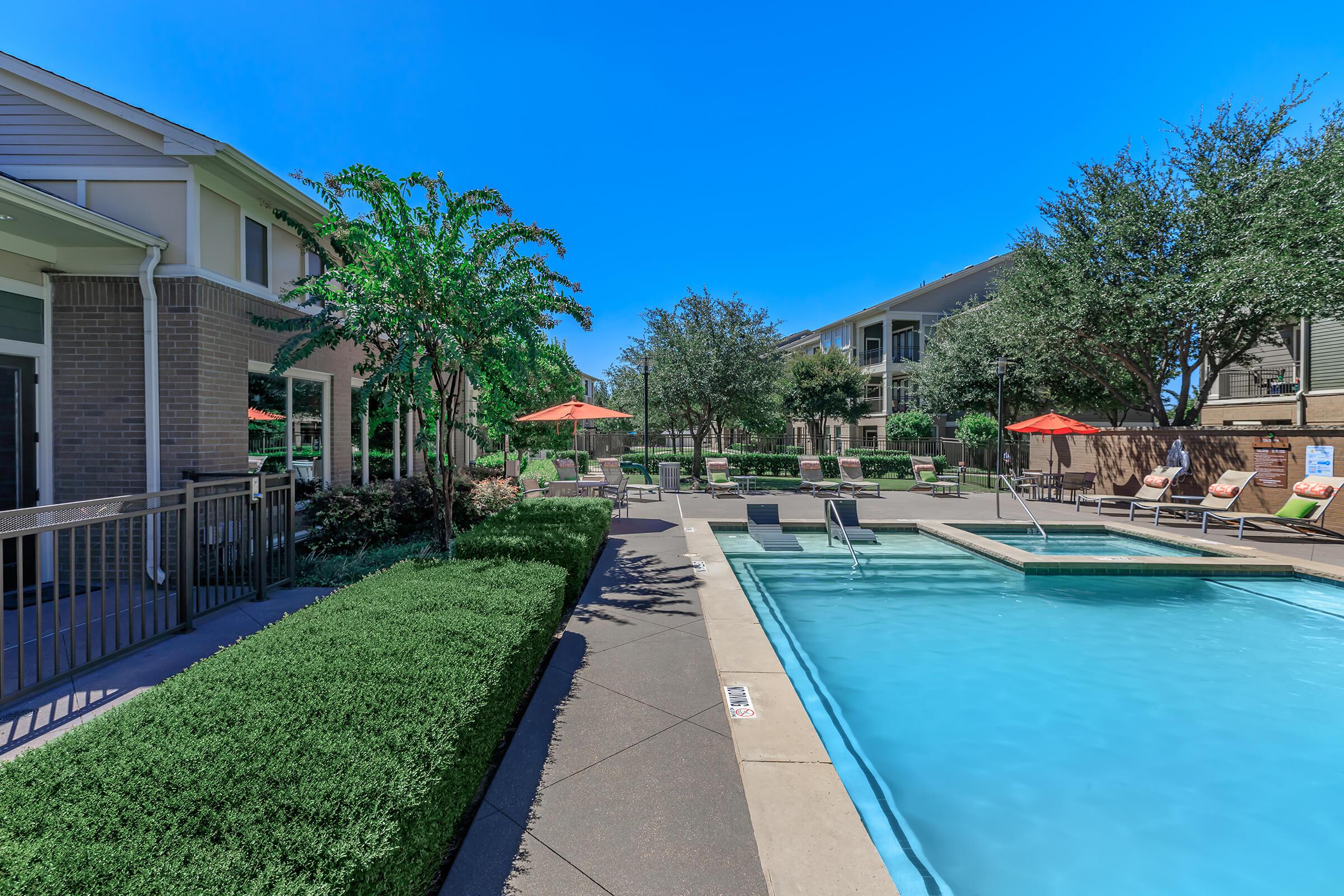 a house with a pool outside of a building