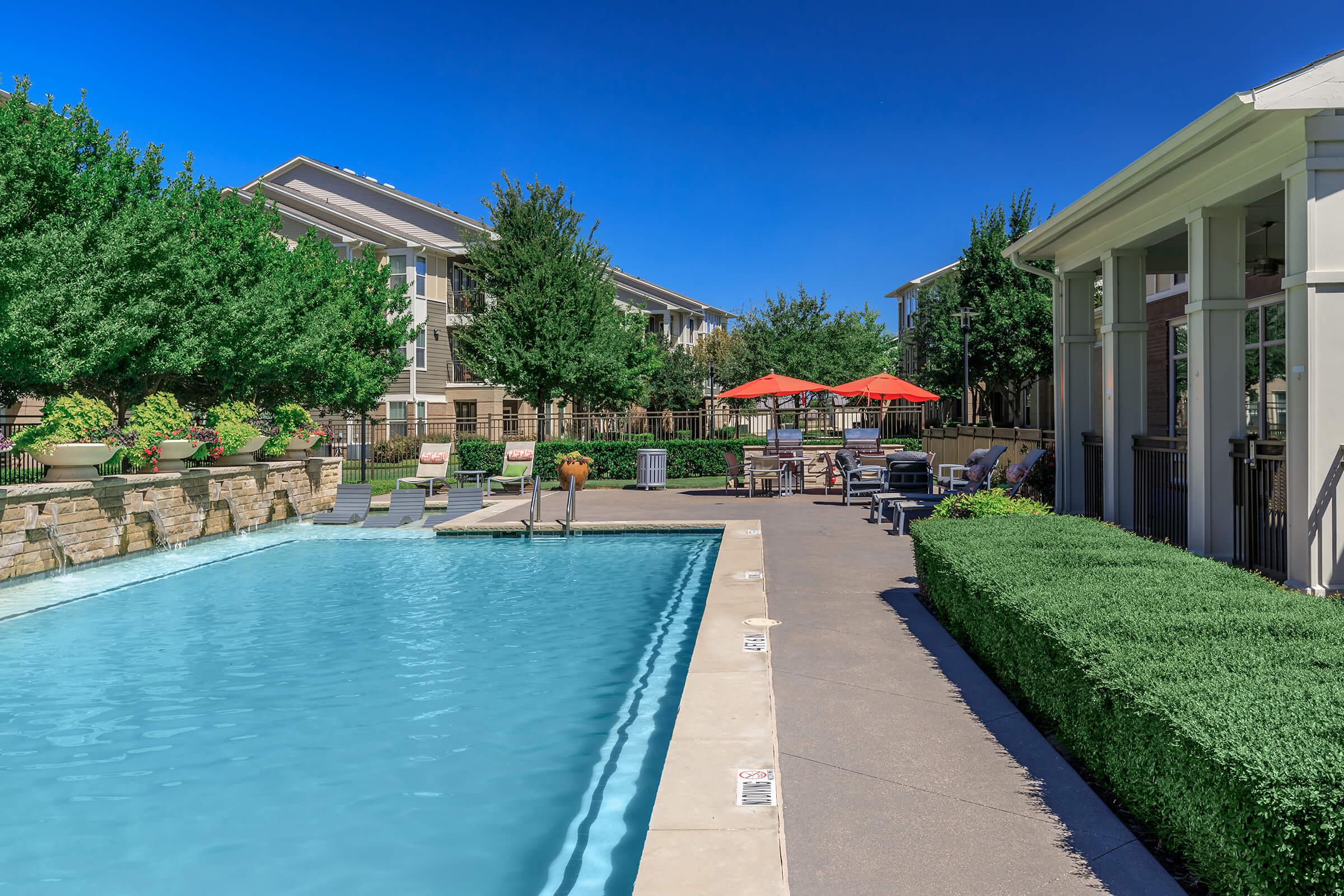 a house with a pool in front of a building