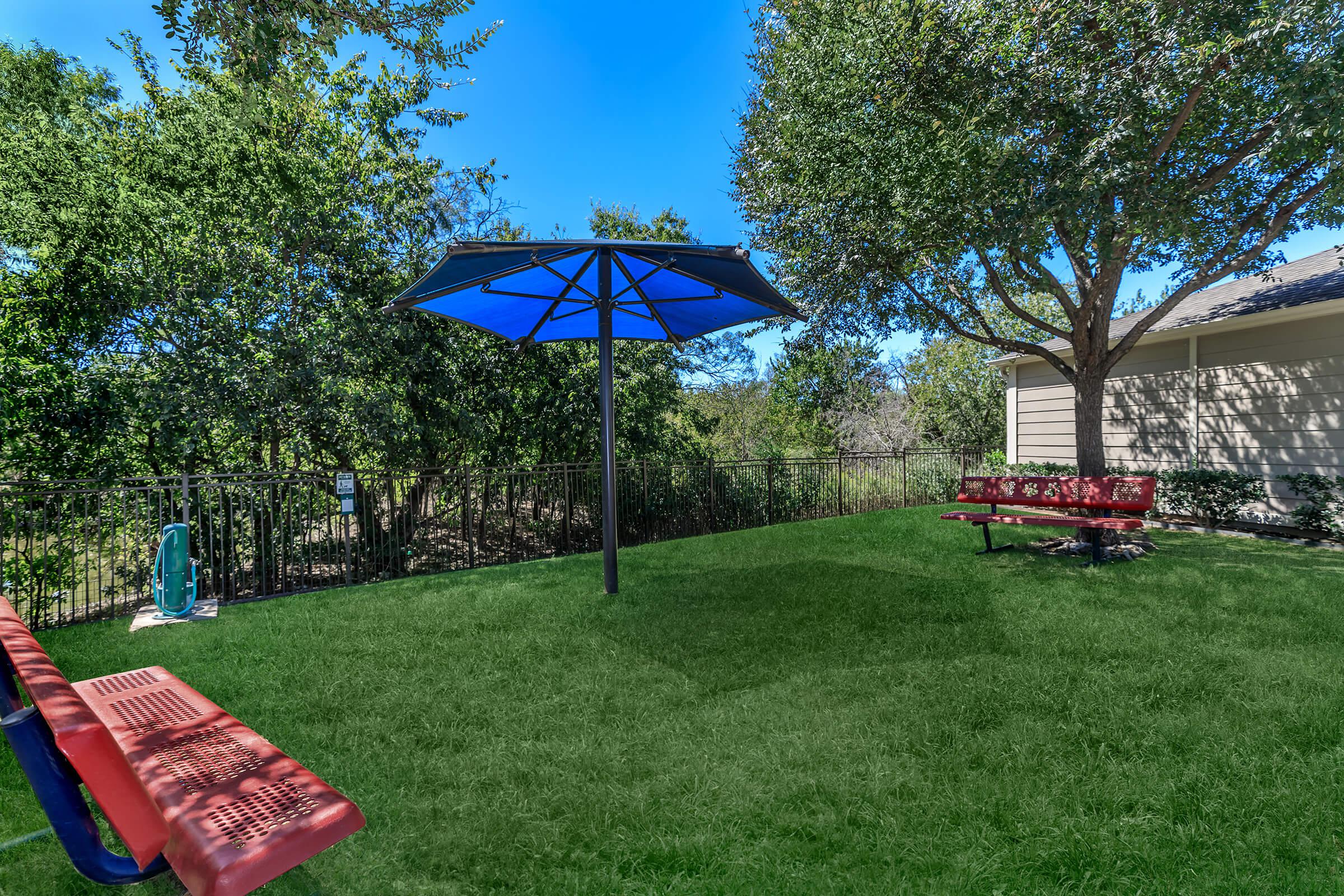 a couple of lawn chairs sitting on top of a grass covered field