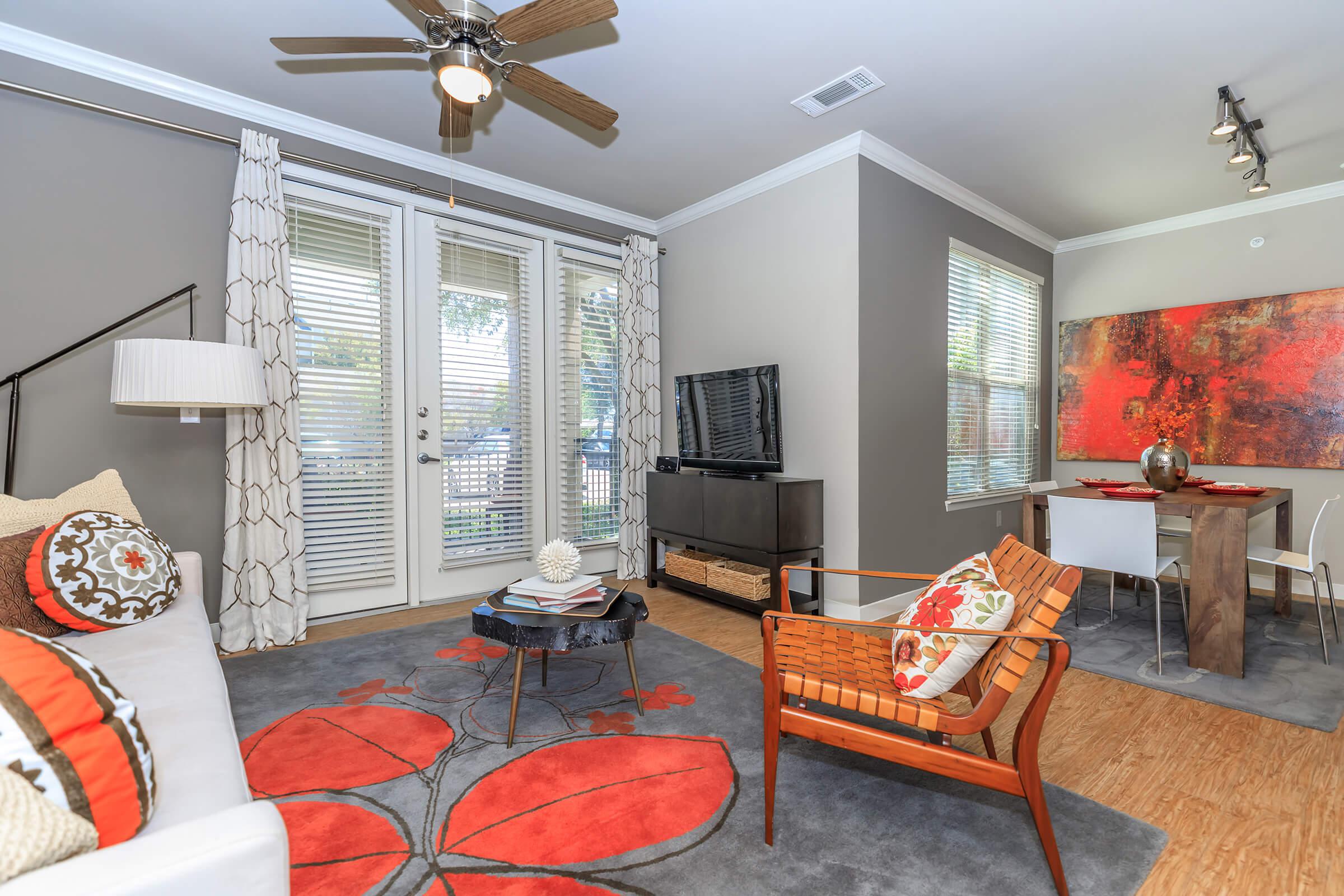 a living room filled with furniture and a large window