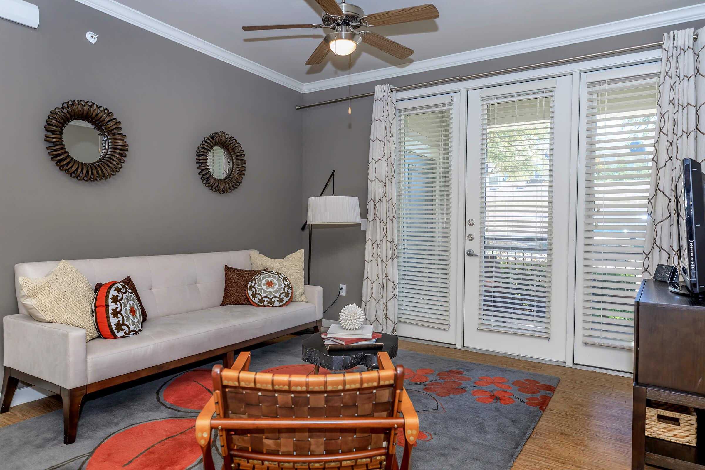 a living room filled with furniture and a large window