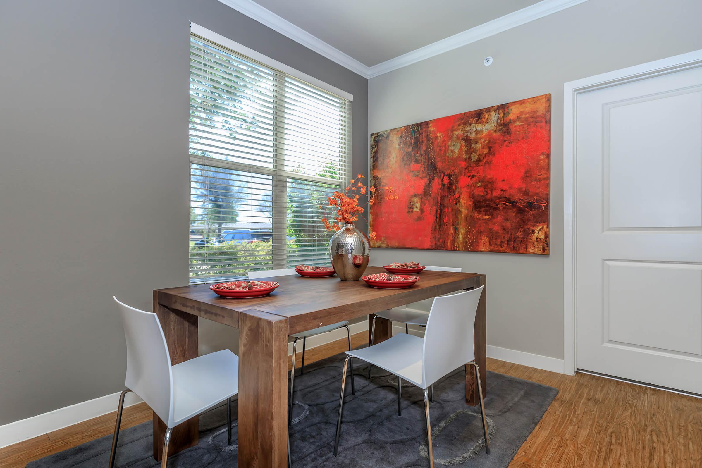 a living room with a table in front of a window