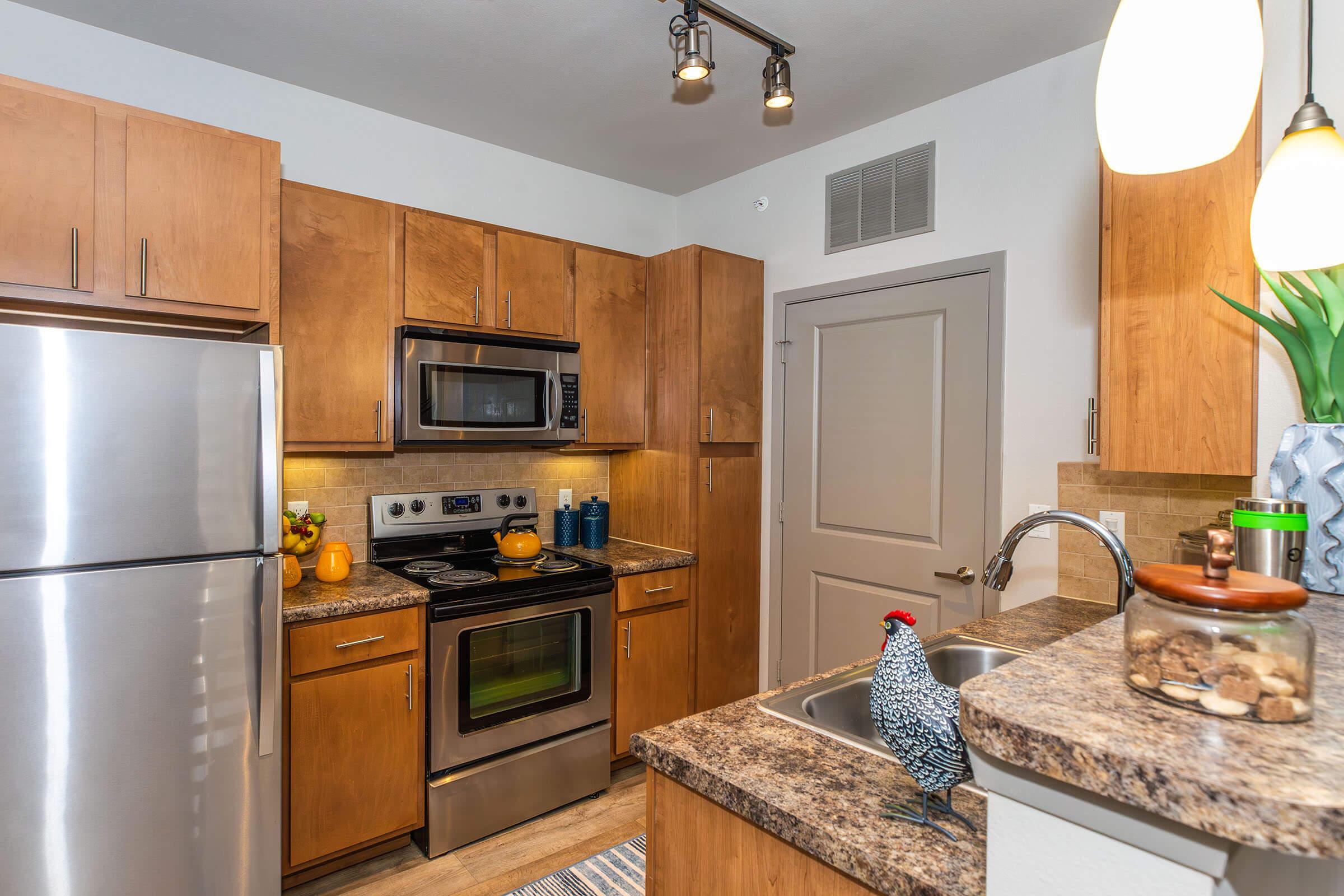 a kitchen with stainless steel appliances and wooden cabinets