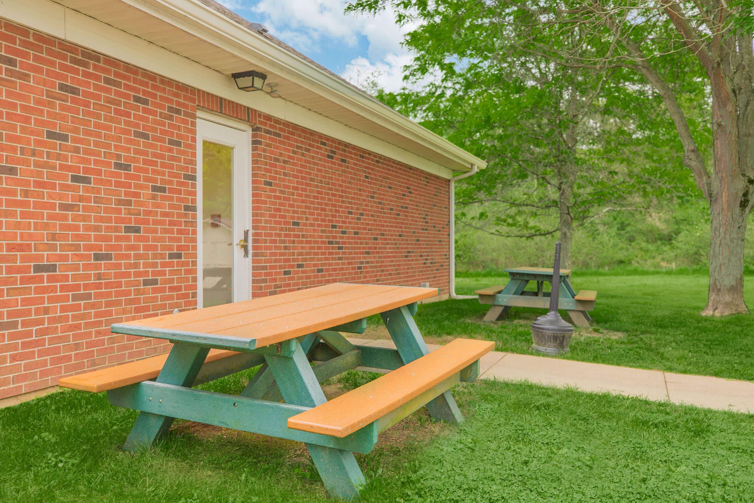 a couple of lawn chairs sitting on top of a picnic table