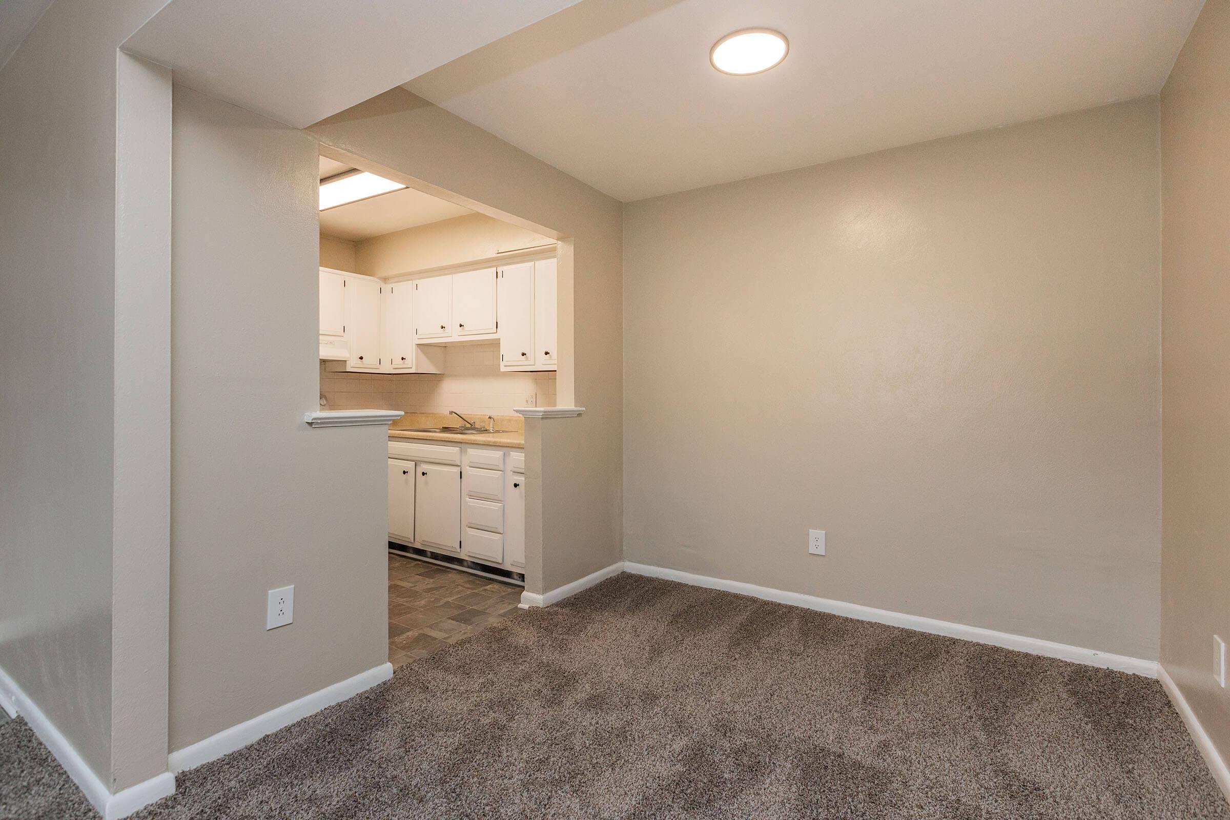 a large empty room with a sink and a mirror