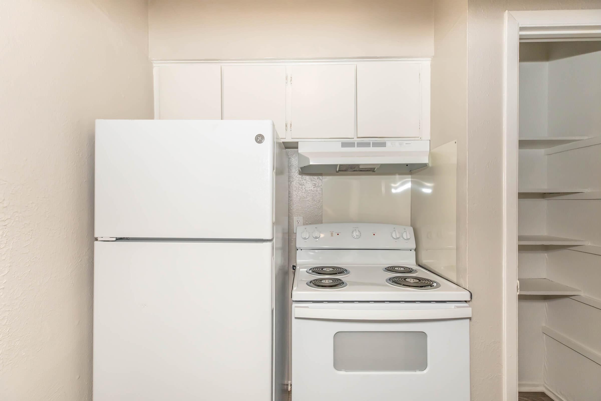 a kitchen with a stove top oven sitting inside of a refrigerator