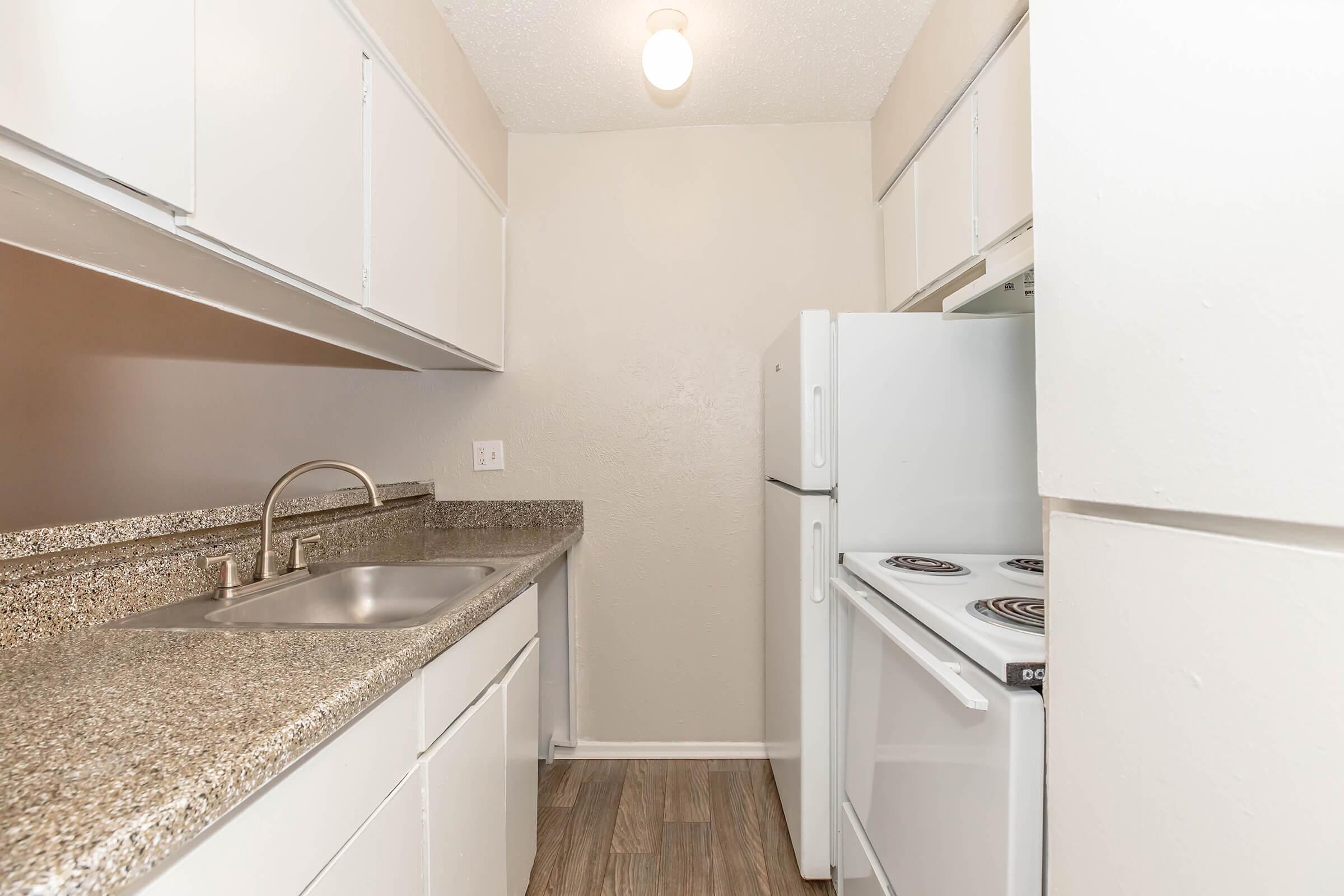 a kitchen with a stove sink and refrigerator