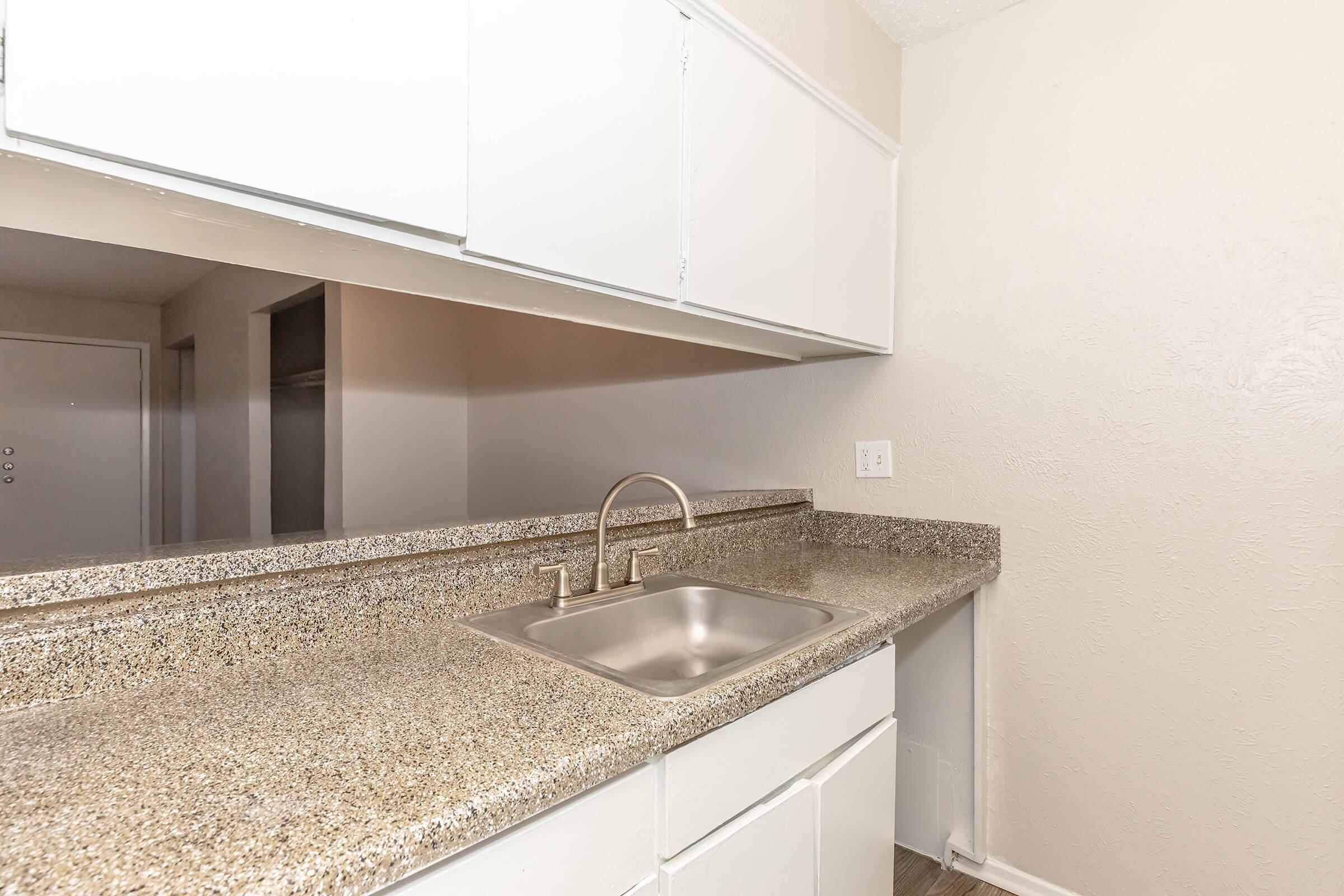 a kitchen with a sink and a mirror