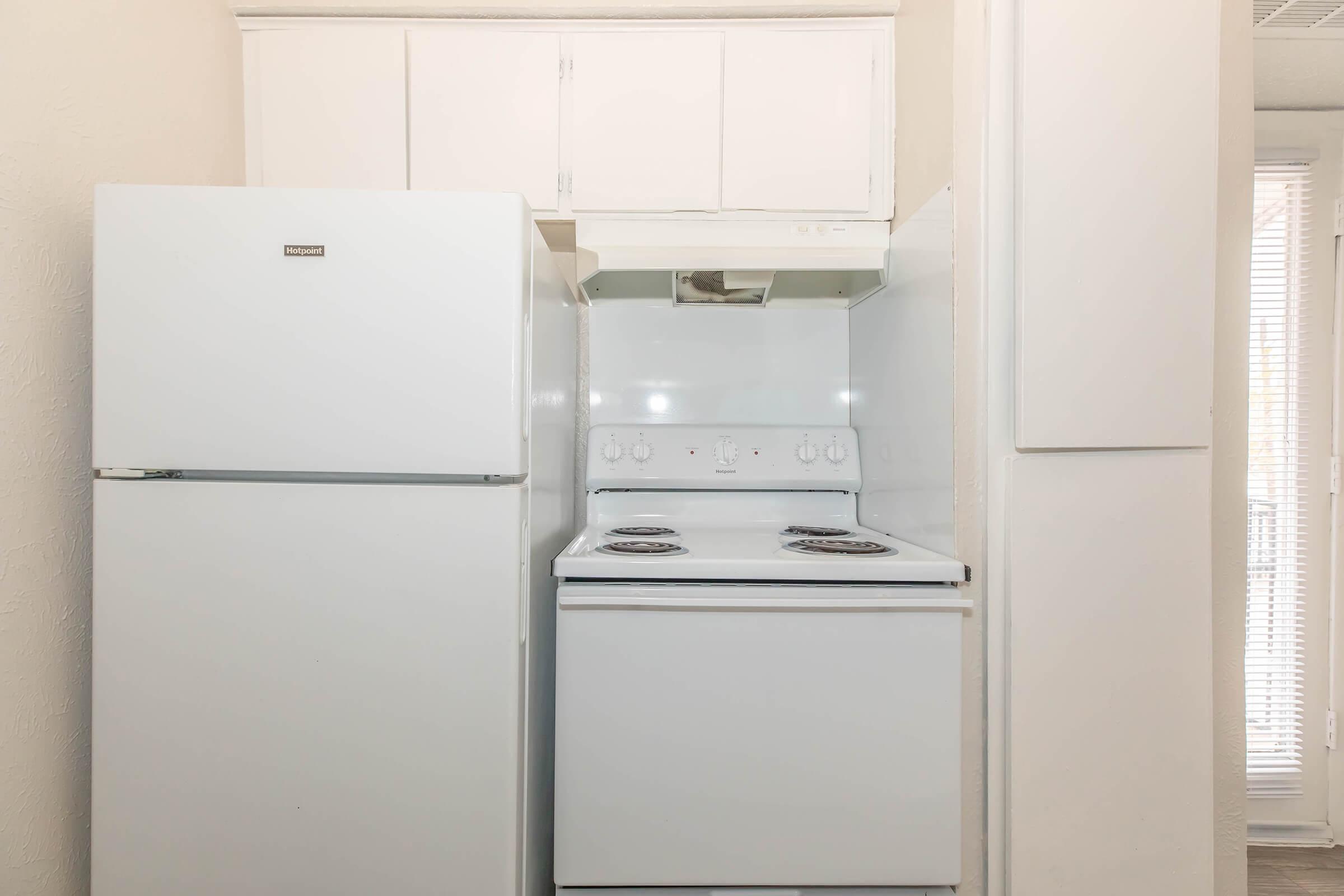 a refrigerator freezer sitting inside of a kitchen