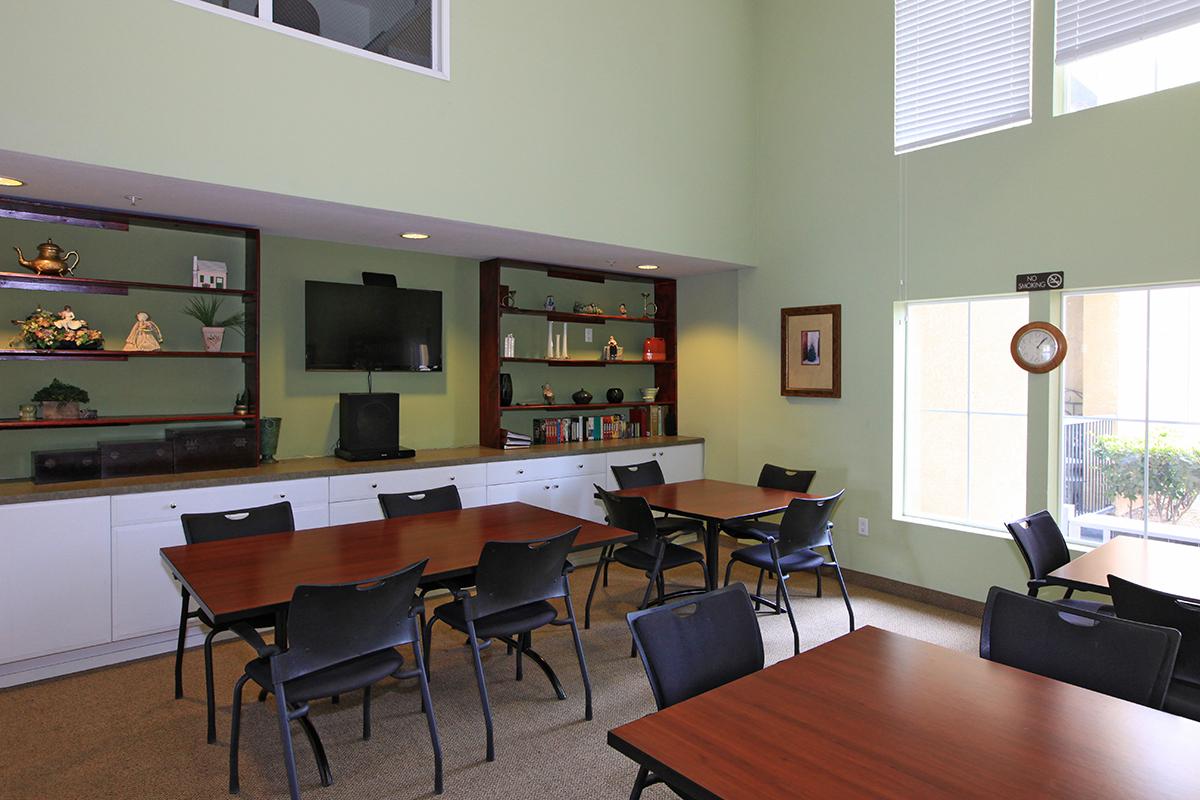 Sungrove Senior Apartment Homes community room with tables and chairs