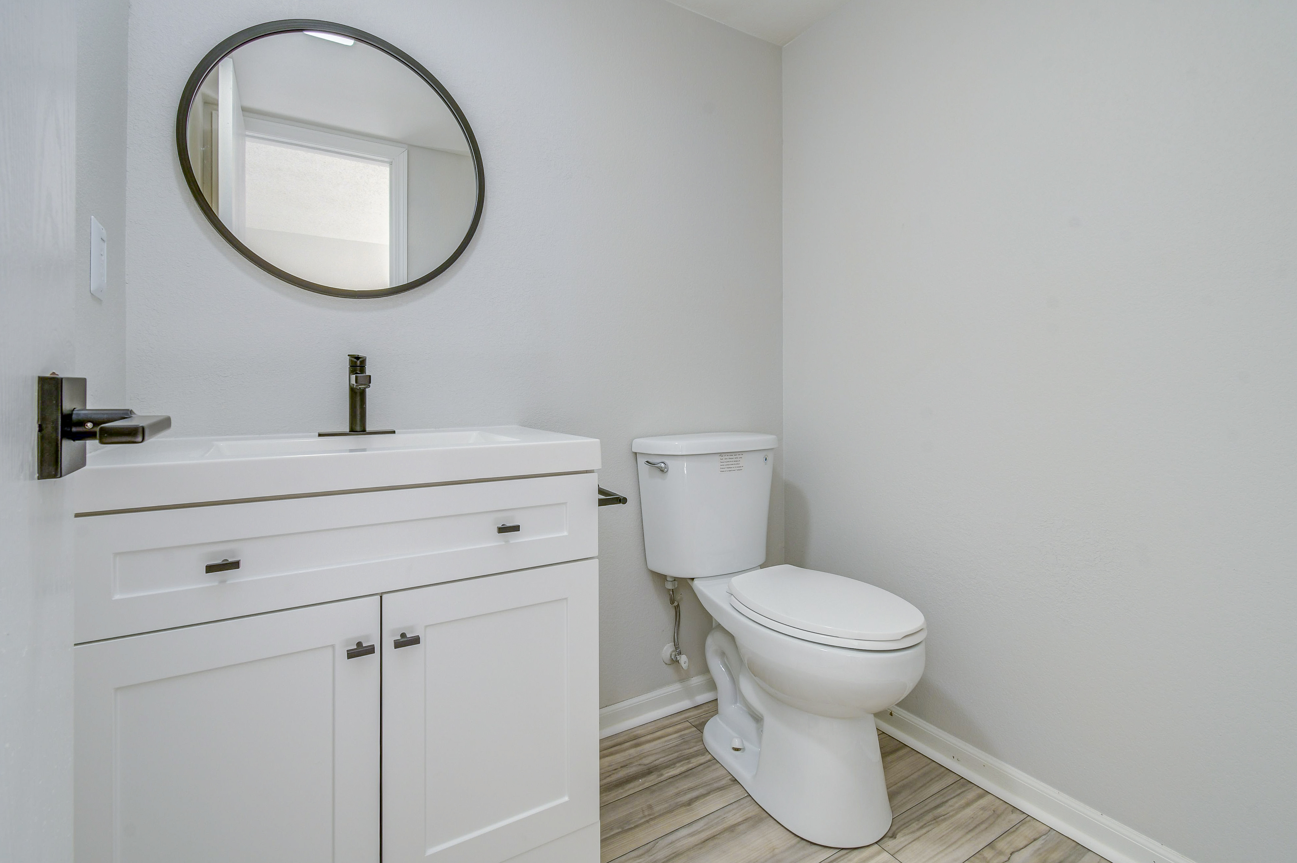 Vanity and toilet in townhome platinum bathroom interior at The Arbor in Blue Springs, Missouri