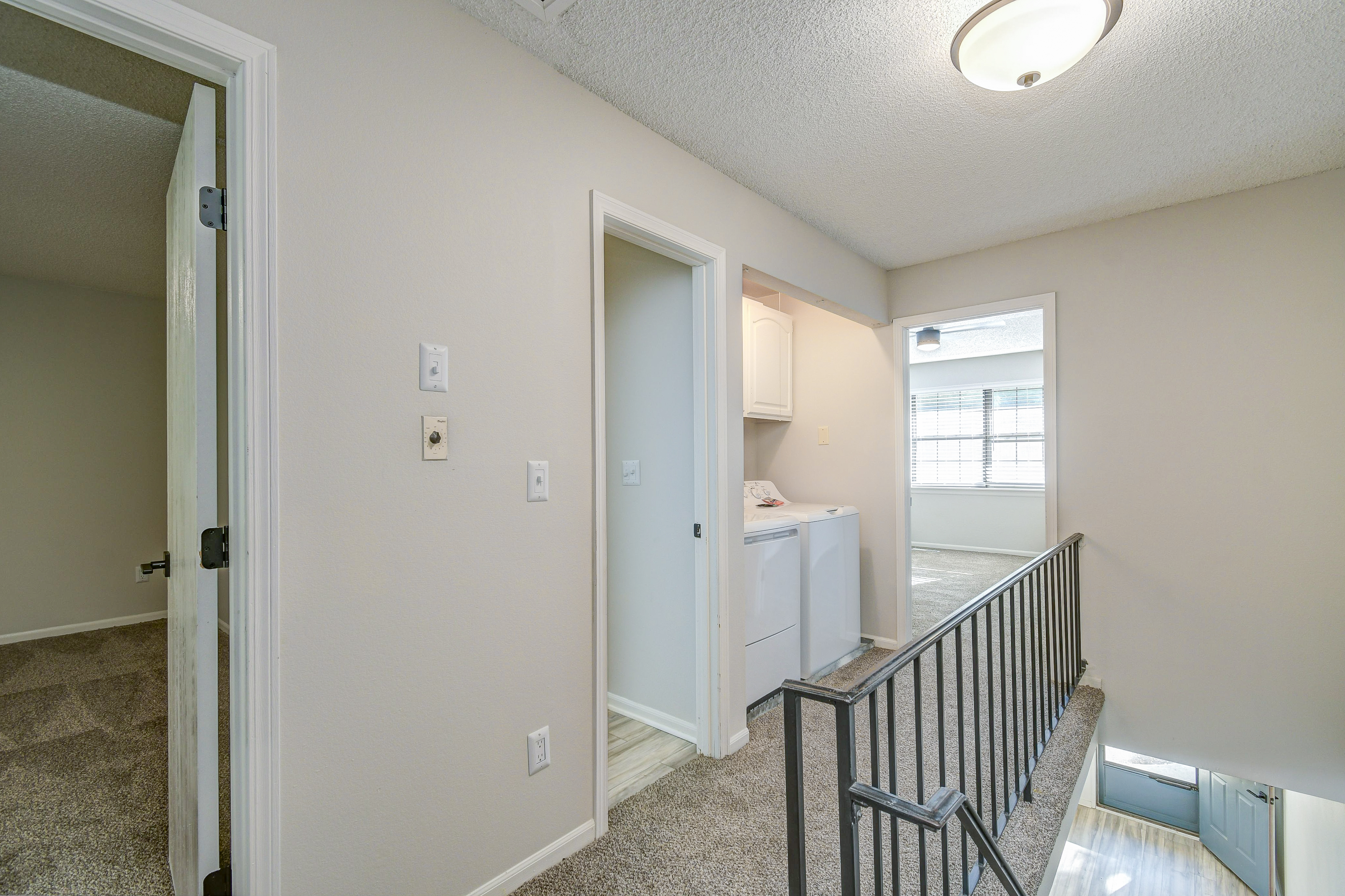 Second floor hallway and railing in townhome platinum interior at The Arbor in Blue Springs, MO