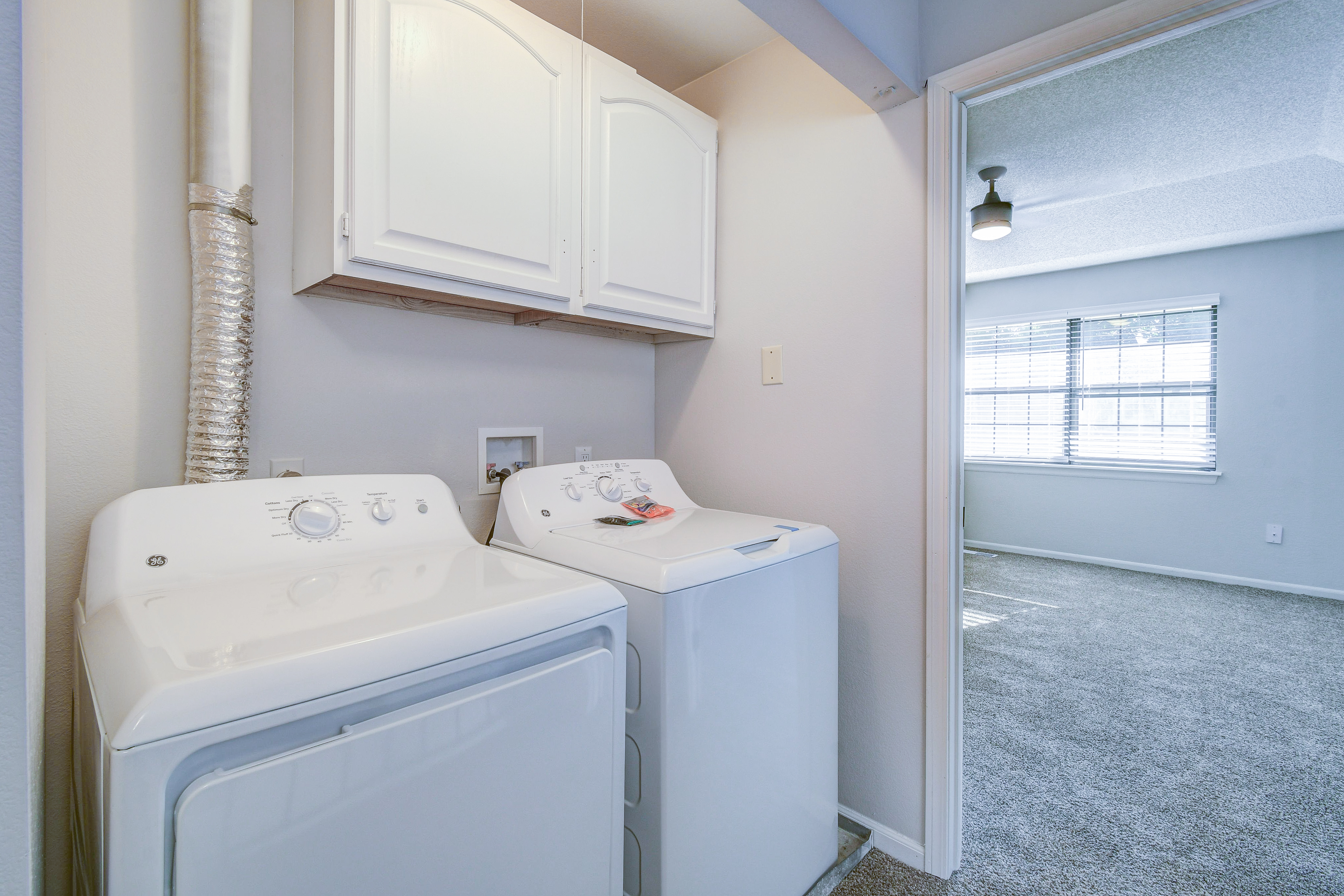 Side by side washer and dryer in townhome platinum interior at The Arbor in Blue Springs, Missouri