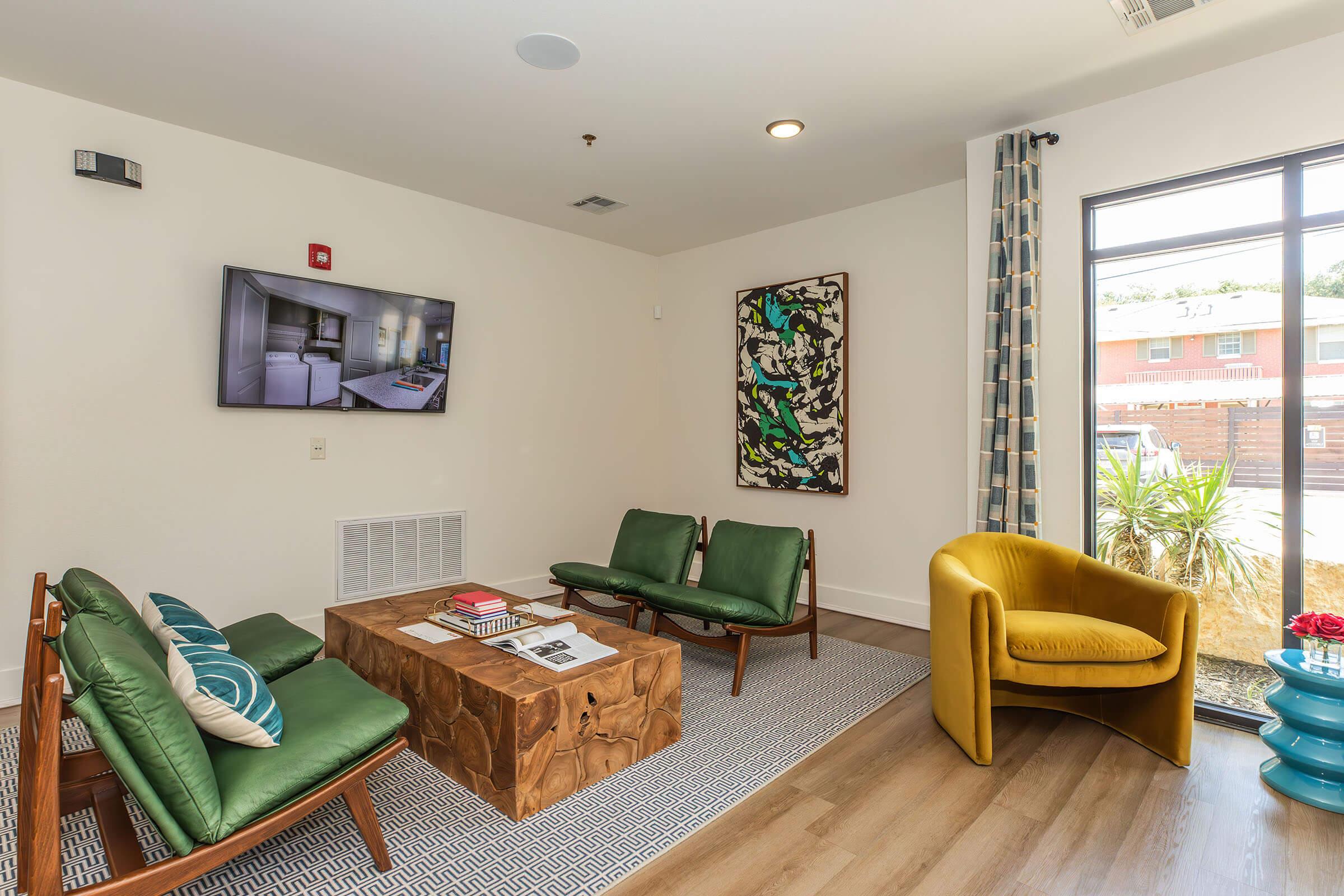 a living room filled with furniture and a large window