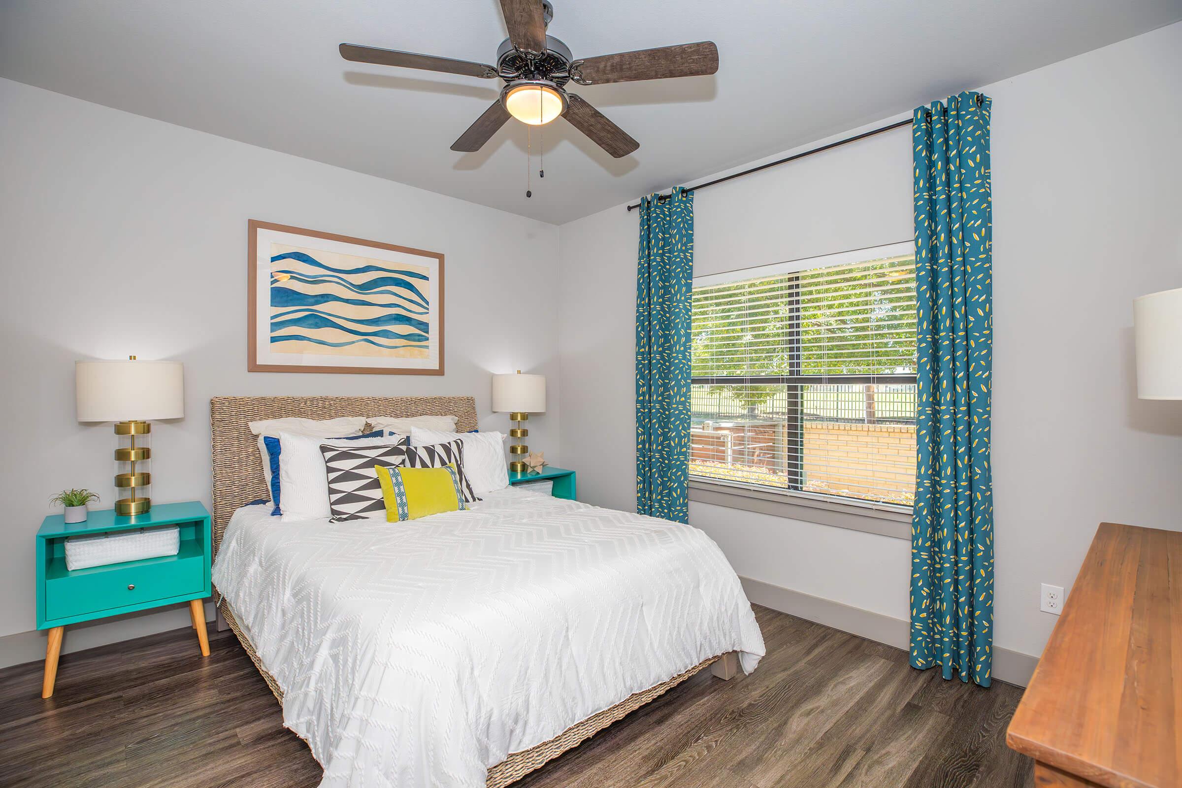 a bedroom with a bed and desk in a room