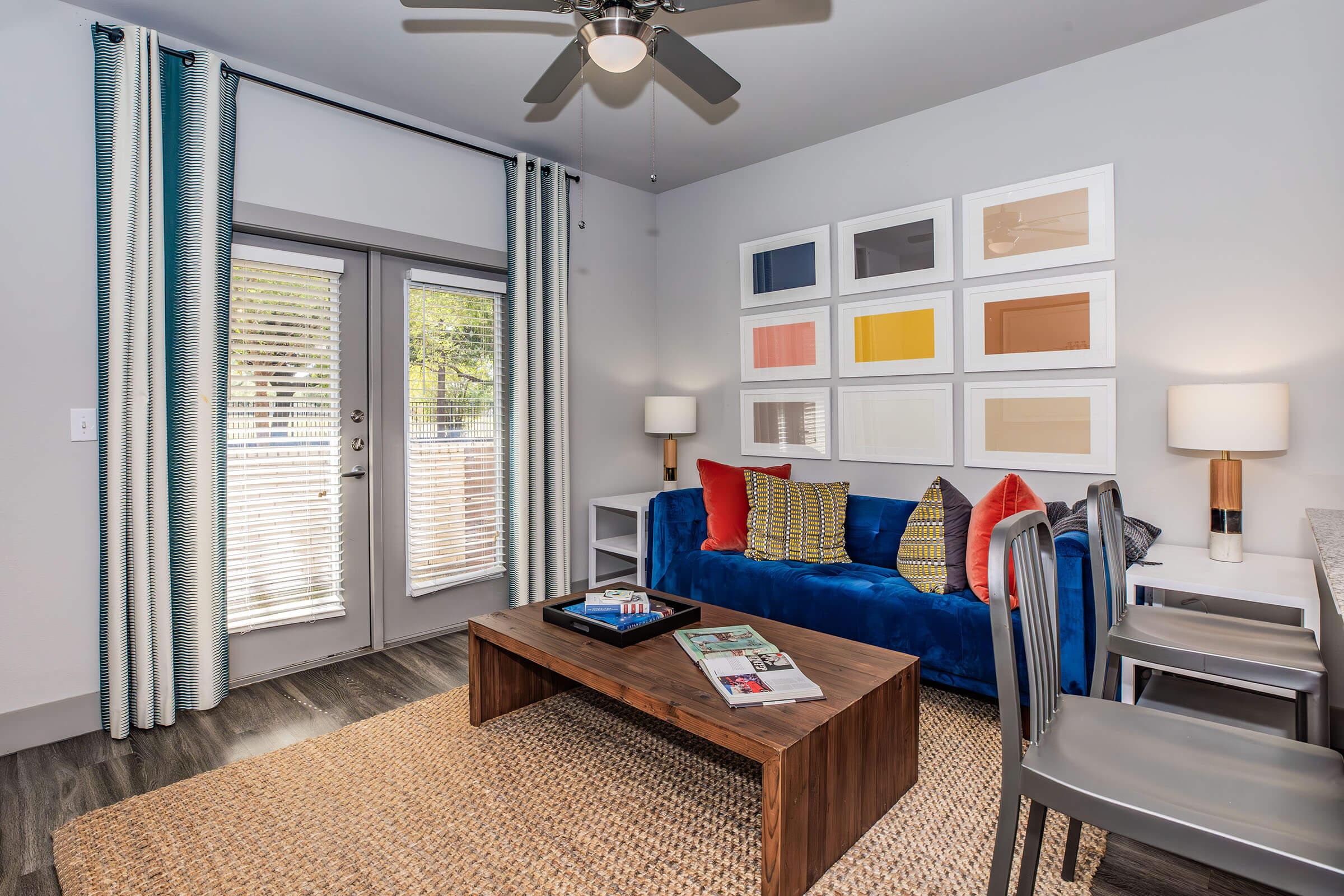 a living room filled with furniture and a large window