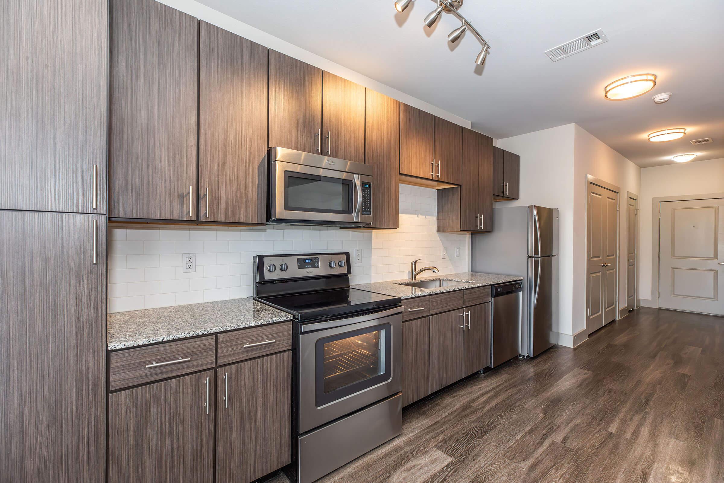 a kitchen with stainless steel appliances and wooden cabinets