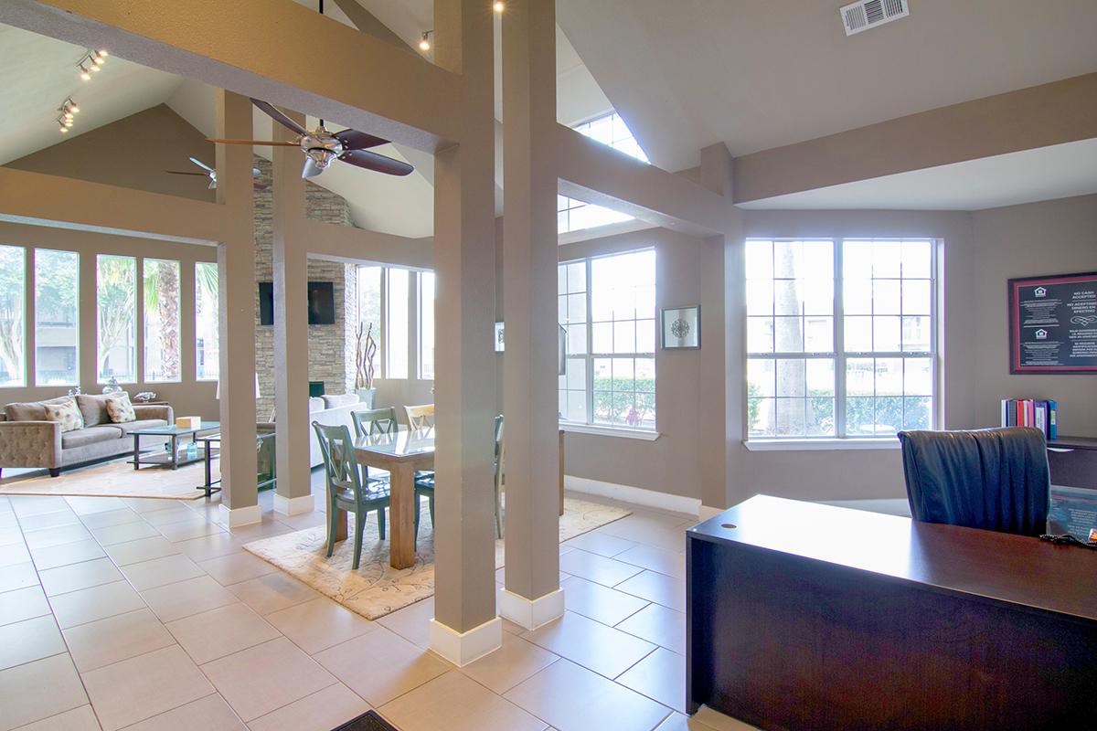 a living room filled with furniture and a large window