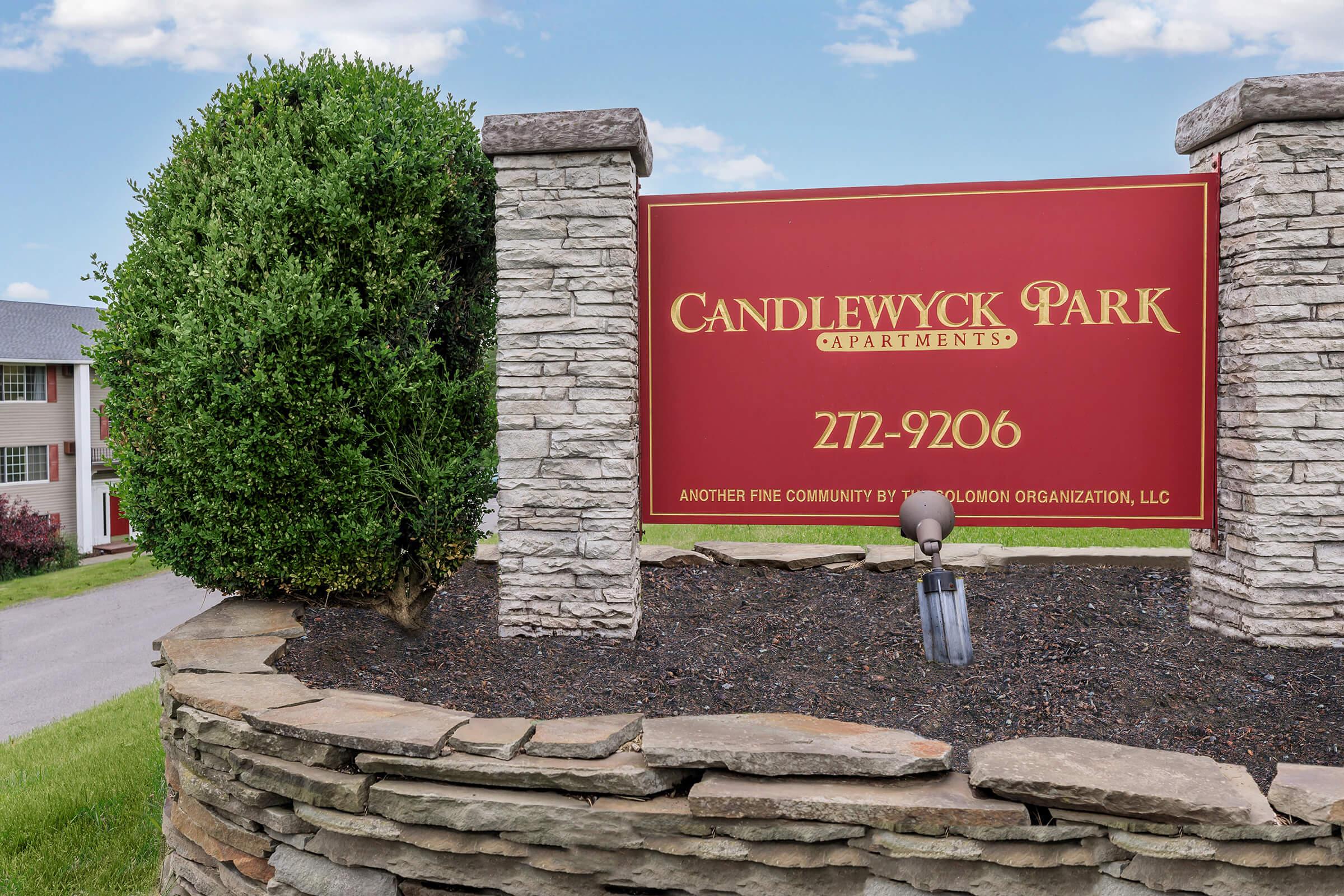 a sign in front of a brick building