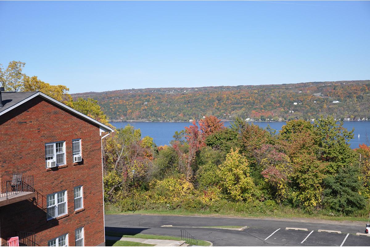 a large brick building with a mountain in the background