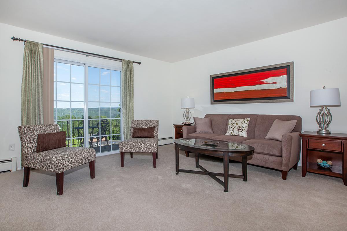 a living room filled with furniture and a large window