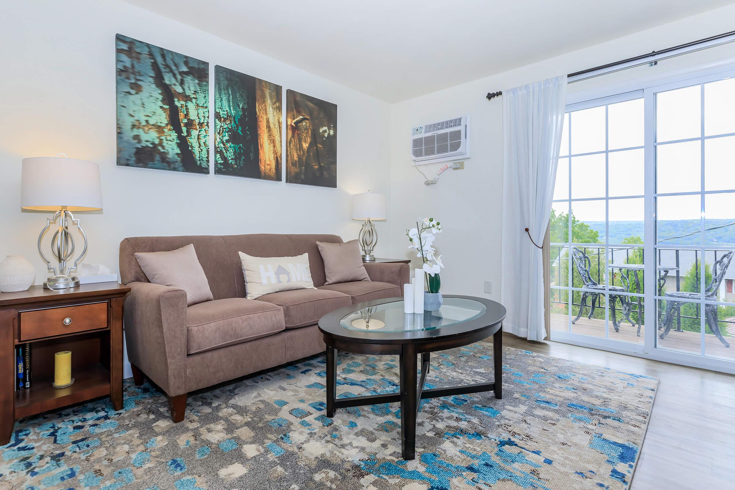 a living room filled with furniture and a large window