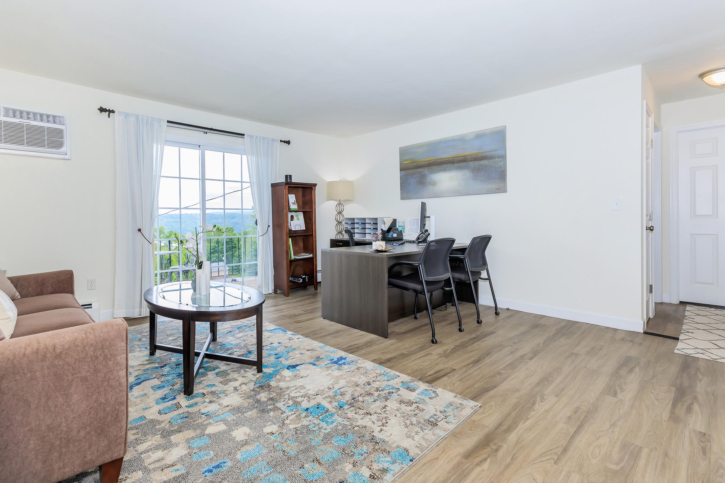 a living room filled with furniture and a large window