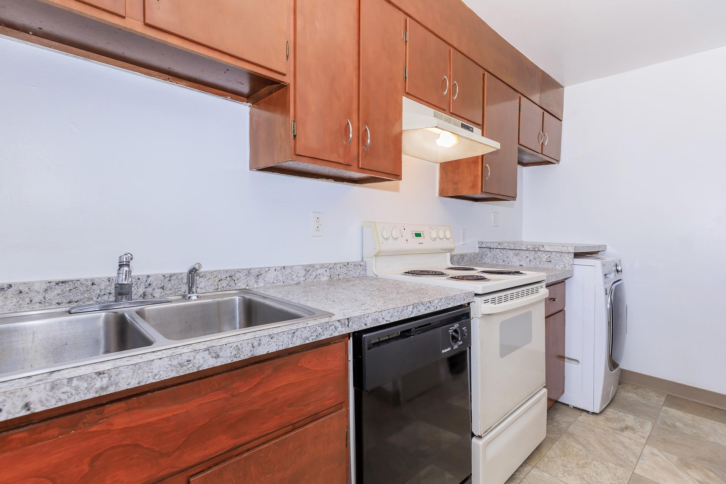 a kitchen with a sink and a mirror