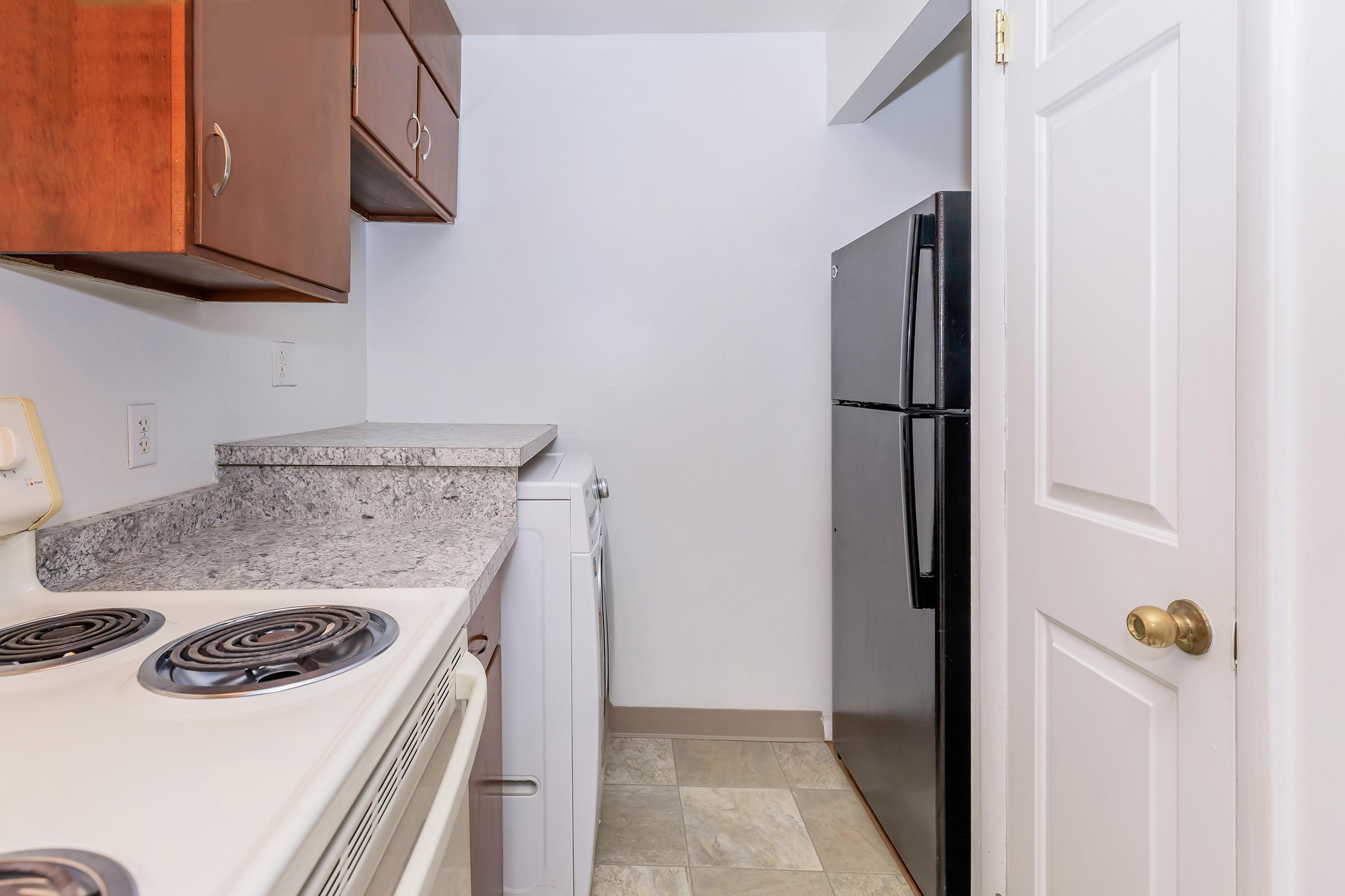 a kitchen with a stove top oven sitting inside of a refrigerator