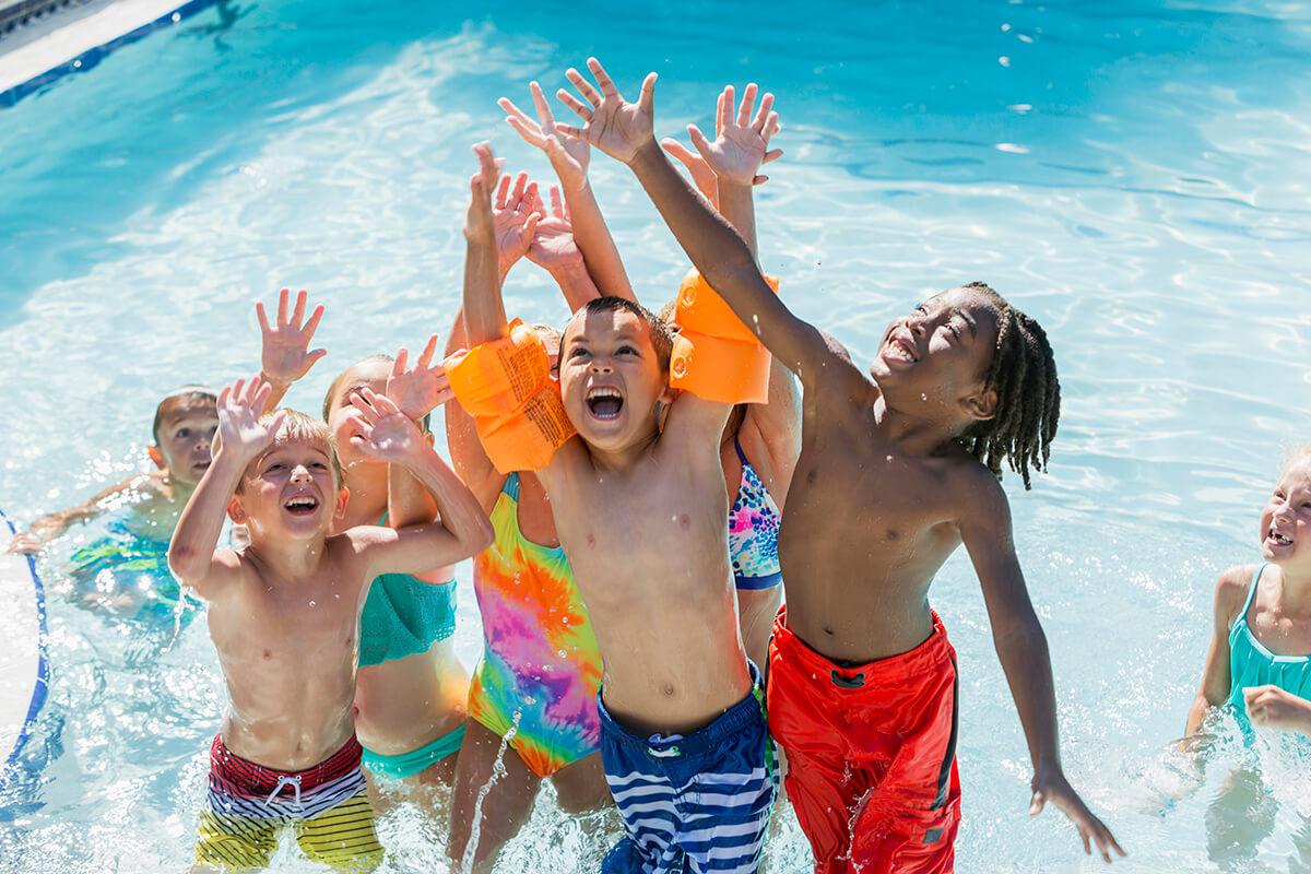a group of people swimming in a pool of water