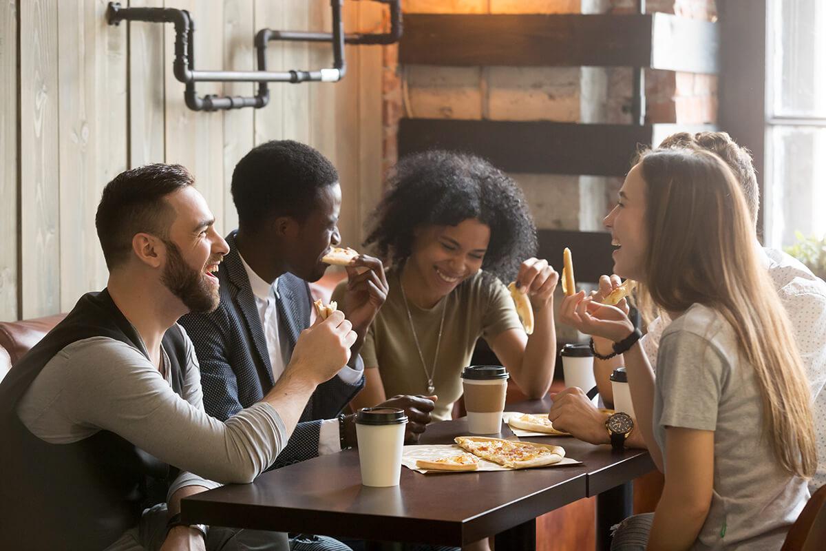 a group of people in a kitchen making food
