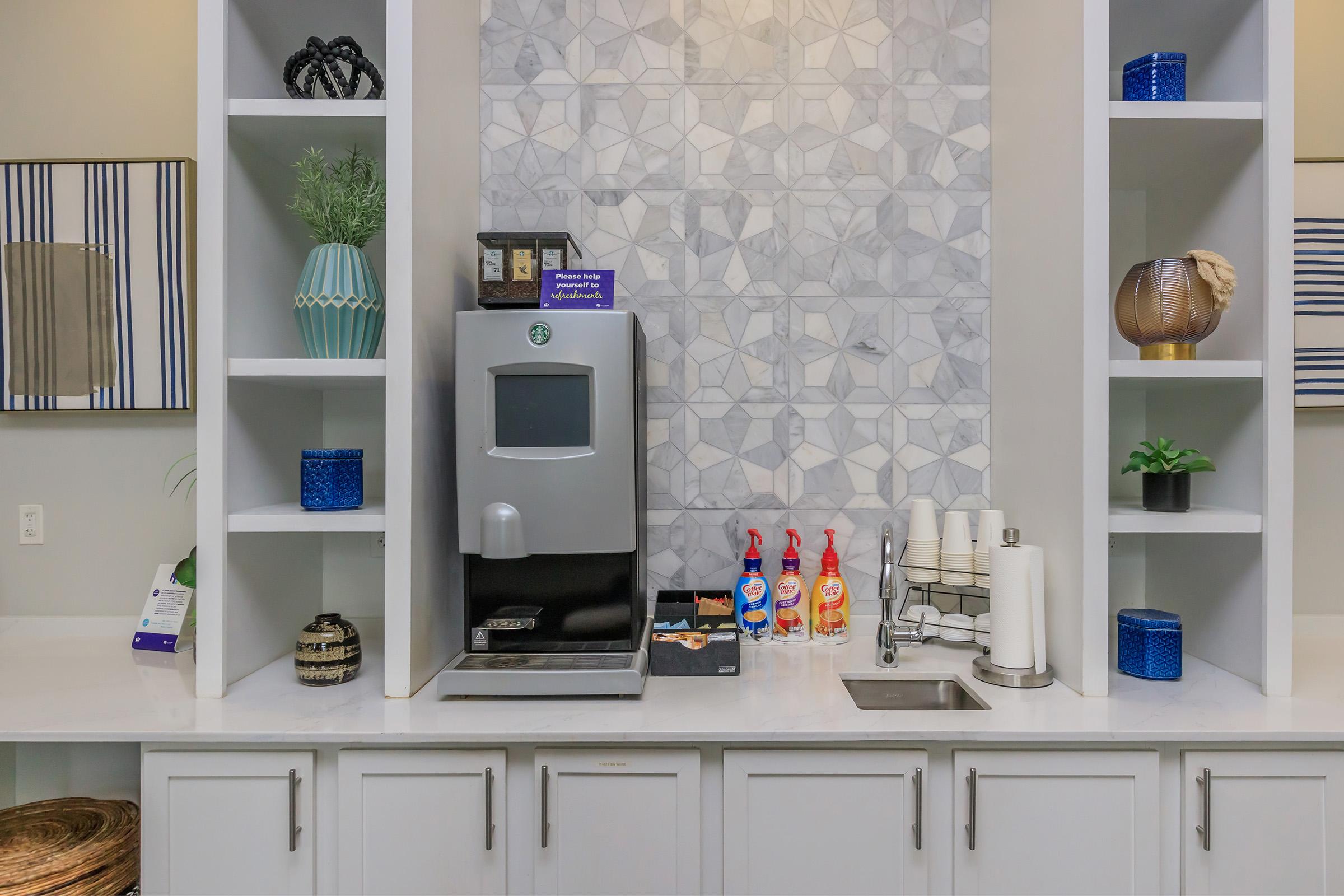 a kitchen with a sink and a mirror