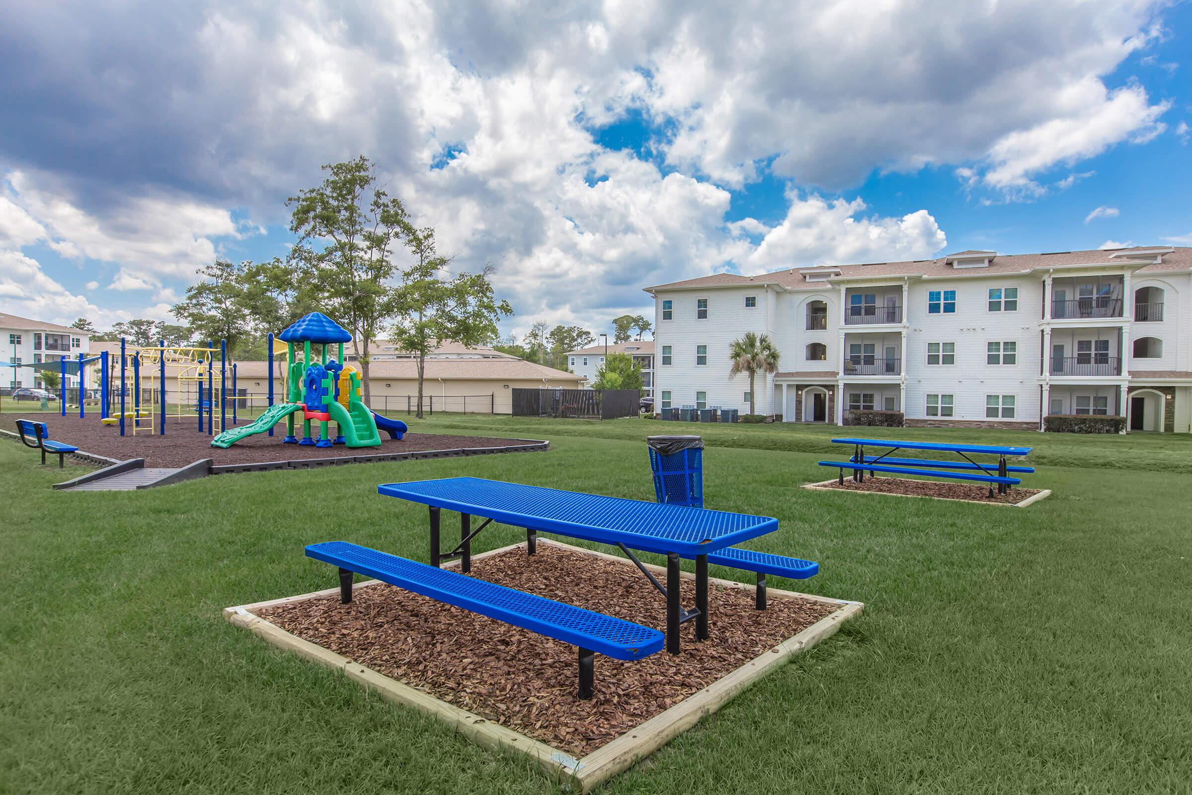 a group of lawn chairs sitting on top of a blue bench