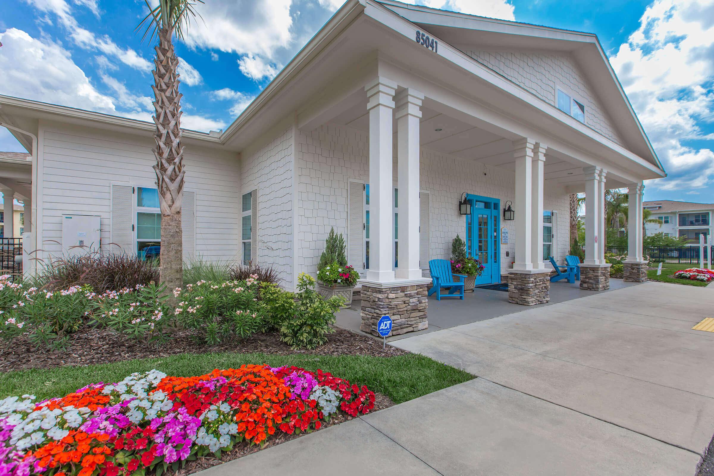 a close up of a flower garden in front of a building