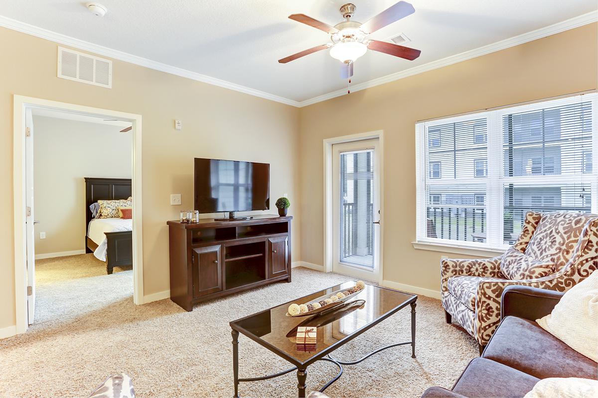 a living room filled with furniture and a flat screen tv