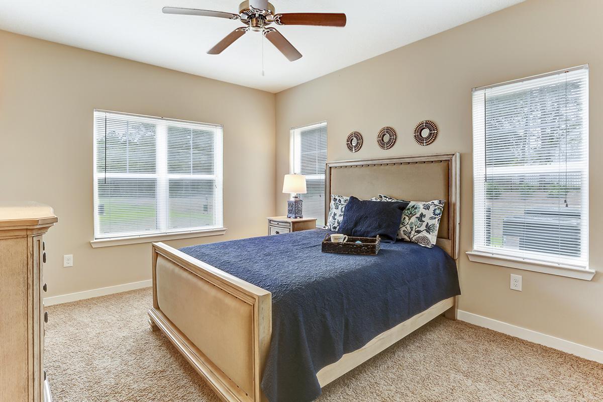 a bedroom with a bed and window in a room