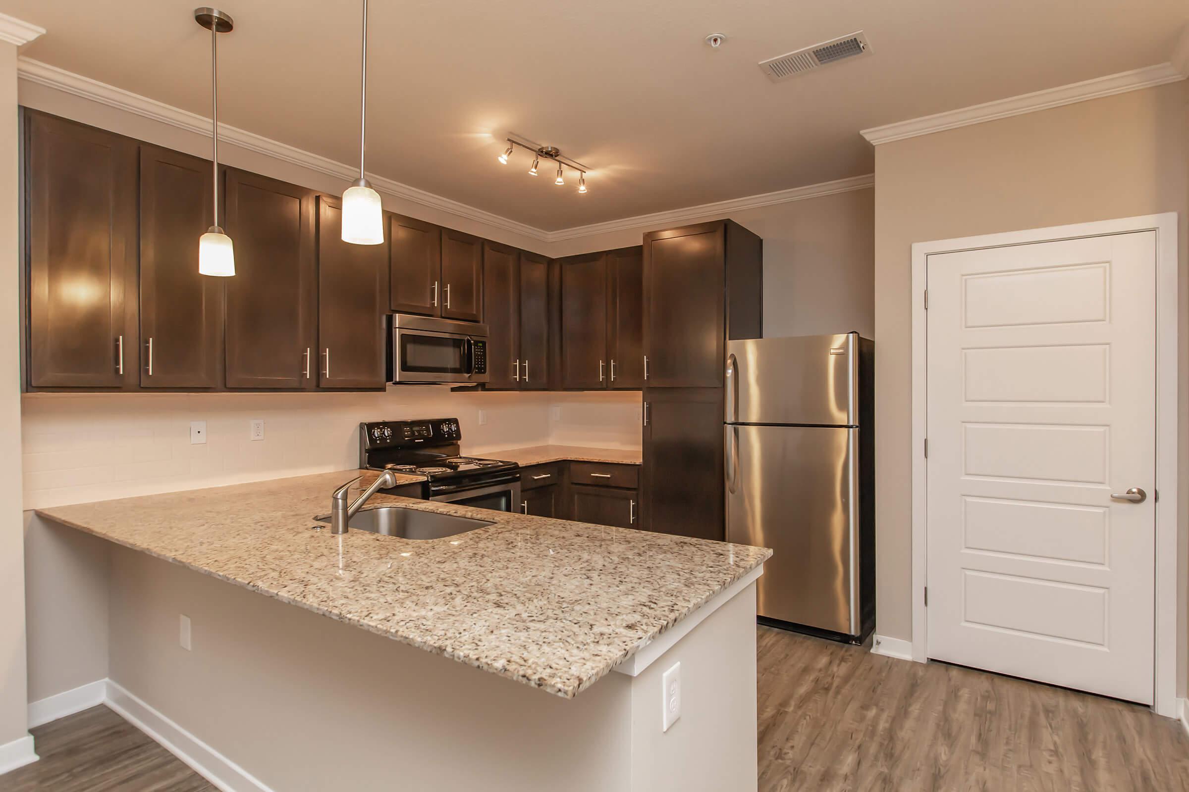 a kitchen with a sink and a mirror