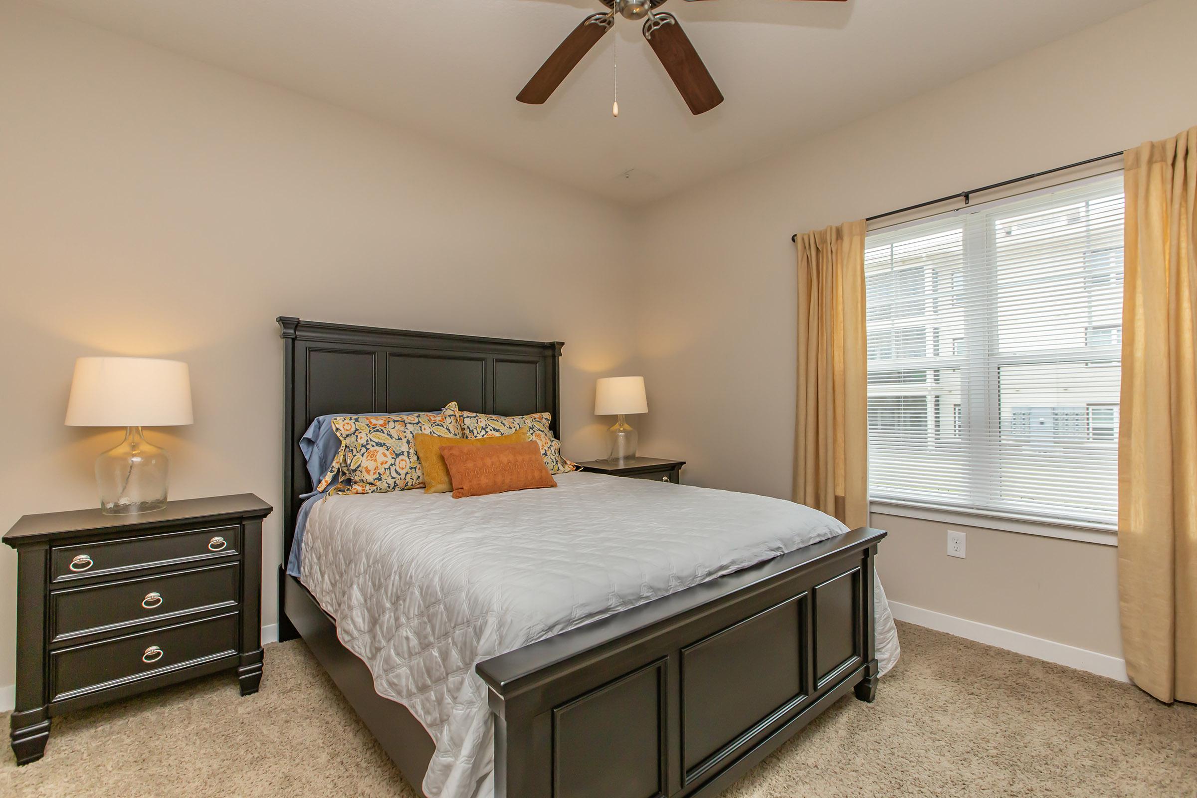 a bedroom with a bed and desk in a room