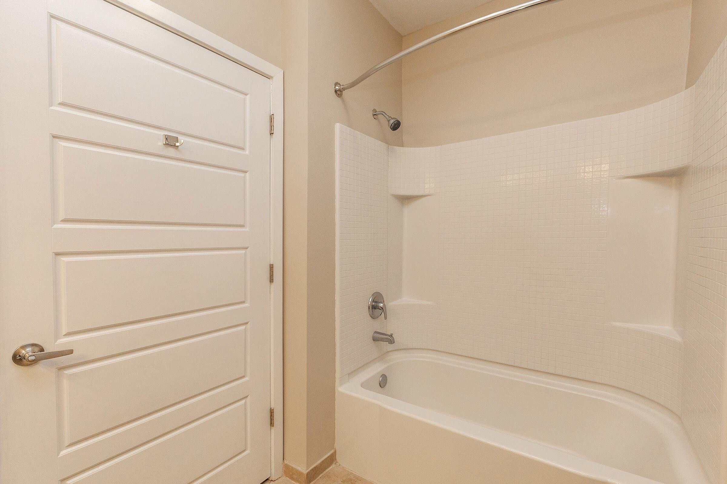 a white tub sitting next to a shower