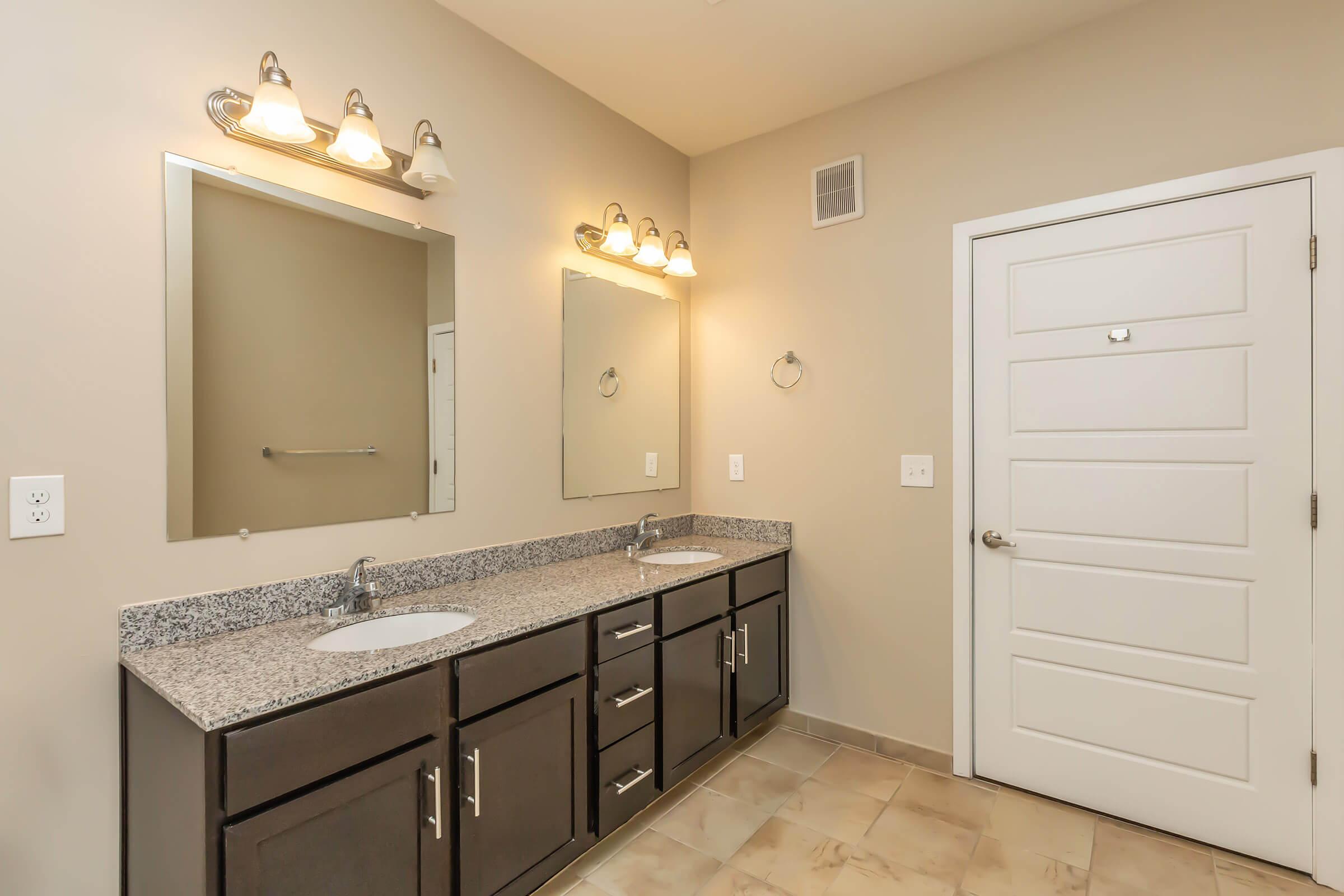 a kitchen with a sink and a mirror