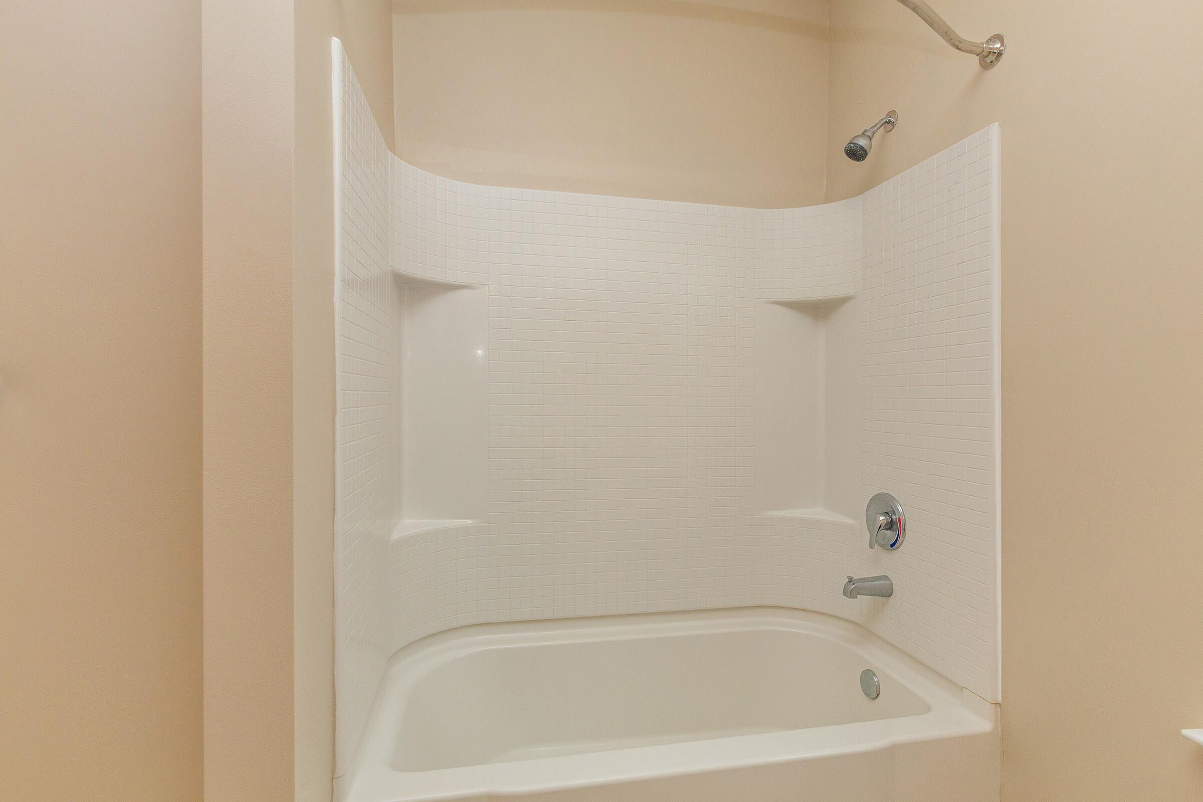 a white tub sitting next to a sink